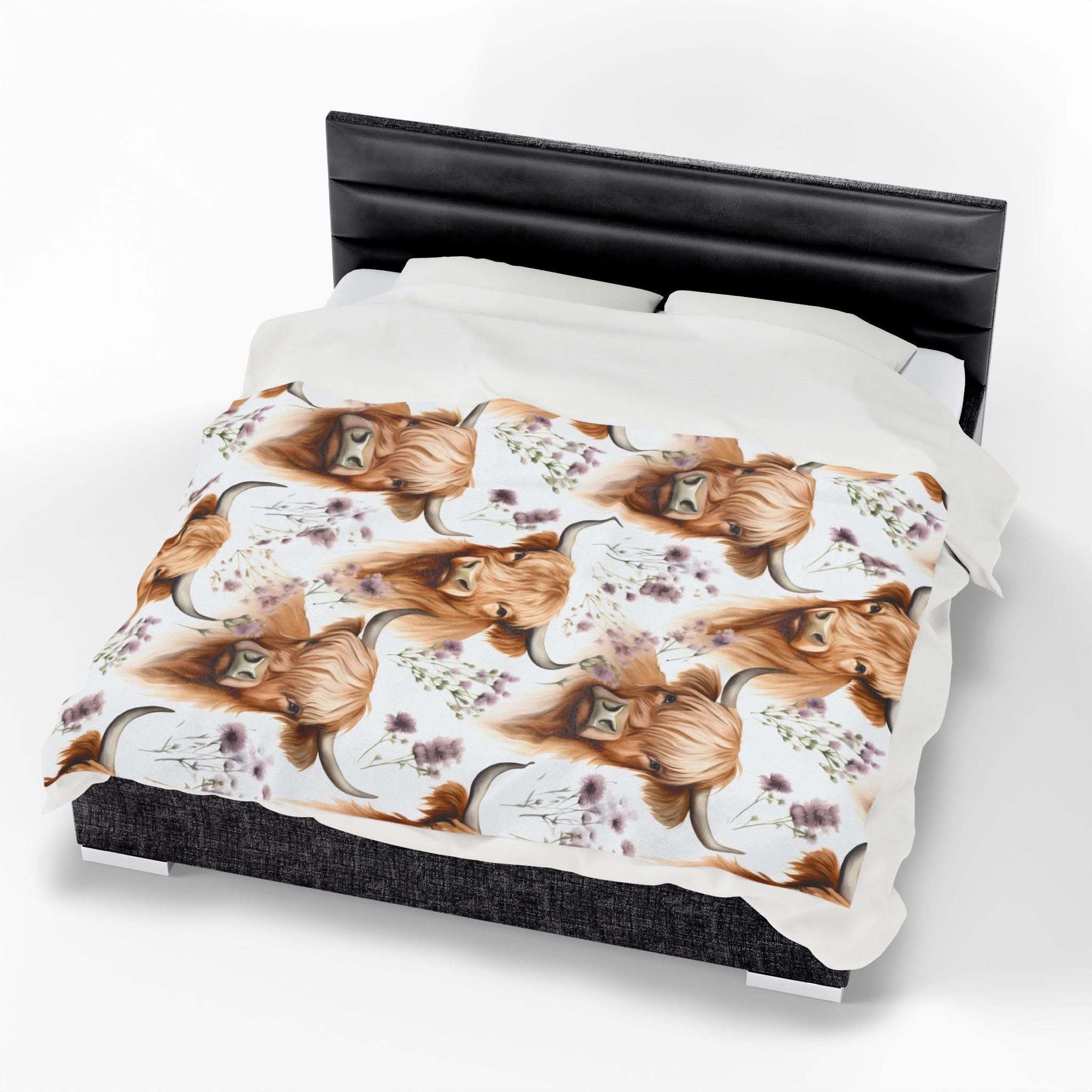 Plush blanket with floral highland cow design on bed, cozy rustic decor fleece throw