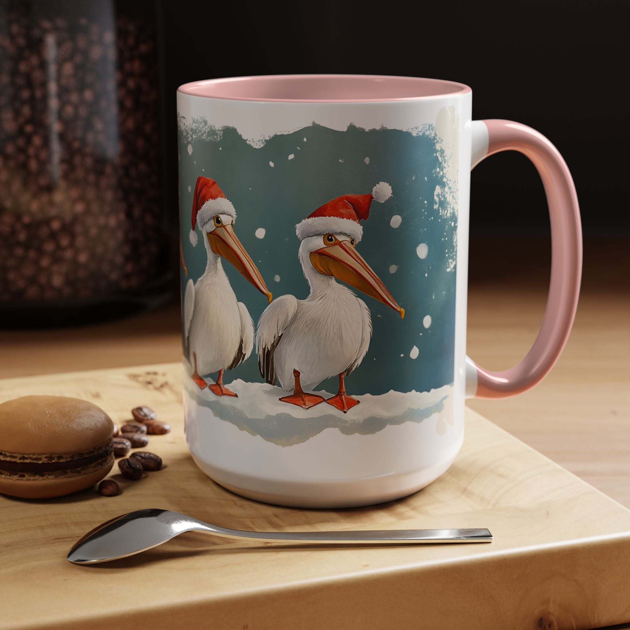 Mug with Christmas-themed design of pelicans wearing Santa hats on a table with coffee beans and a spoon.