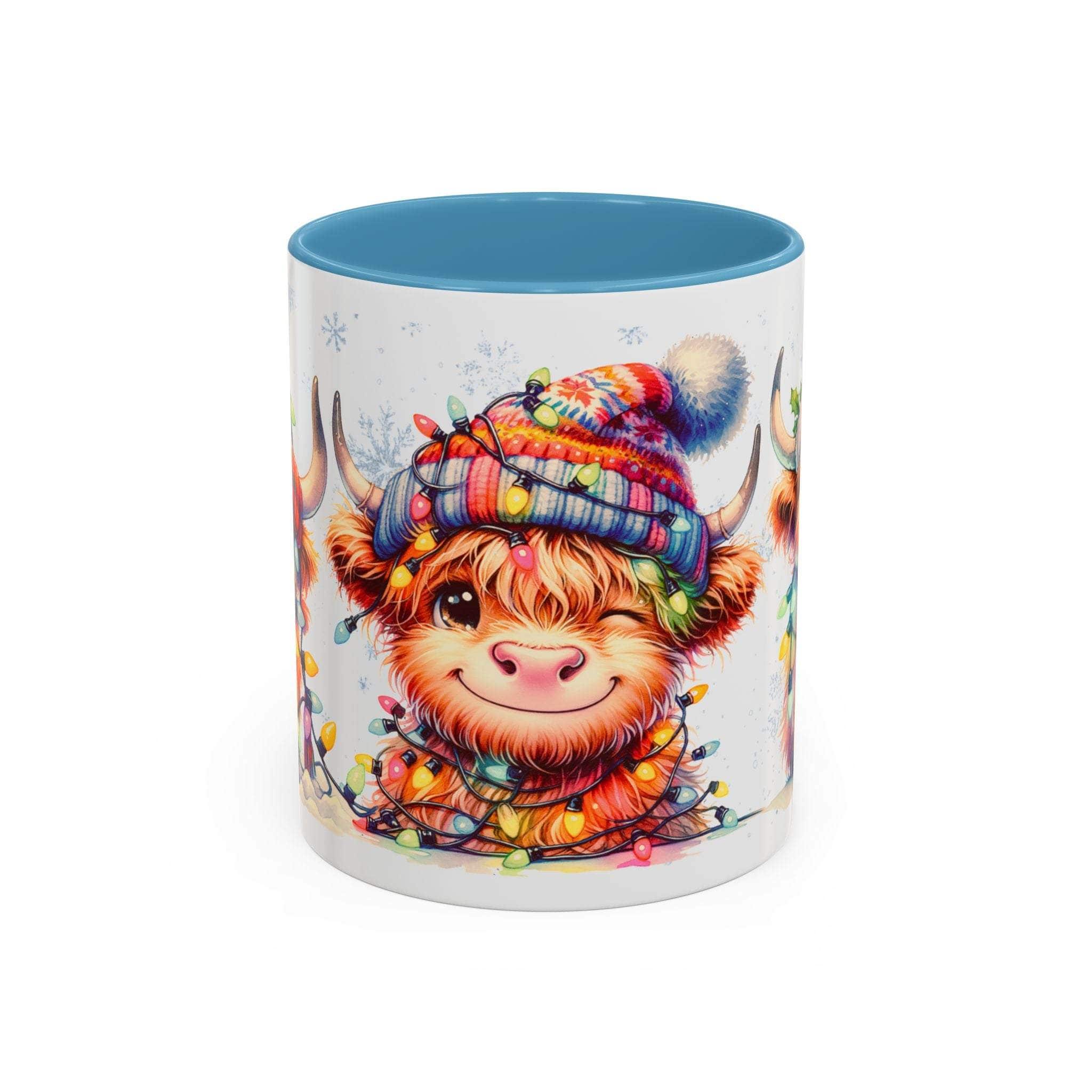 Mug with a cartoon Highland cow wearing a colorful hat and surrounded by lights on a white background