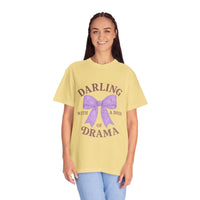 Woman wearing a yellow t-shirt with a purple bow and text on a white background
