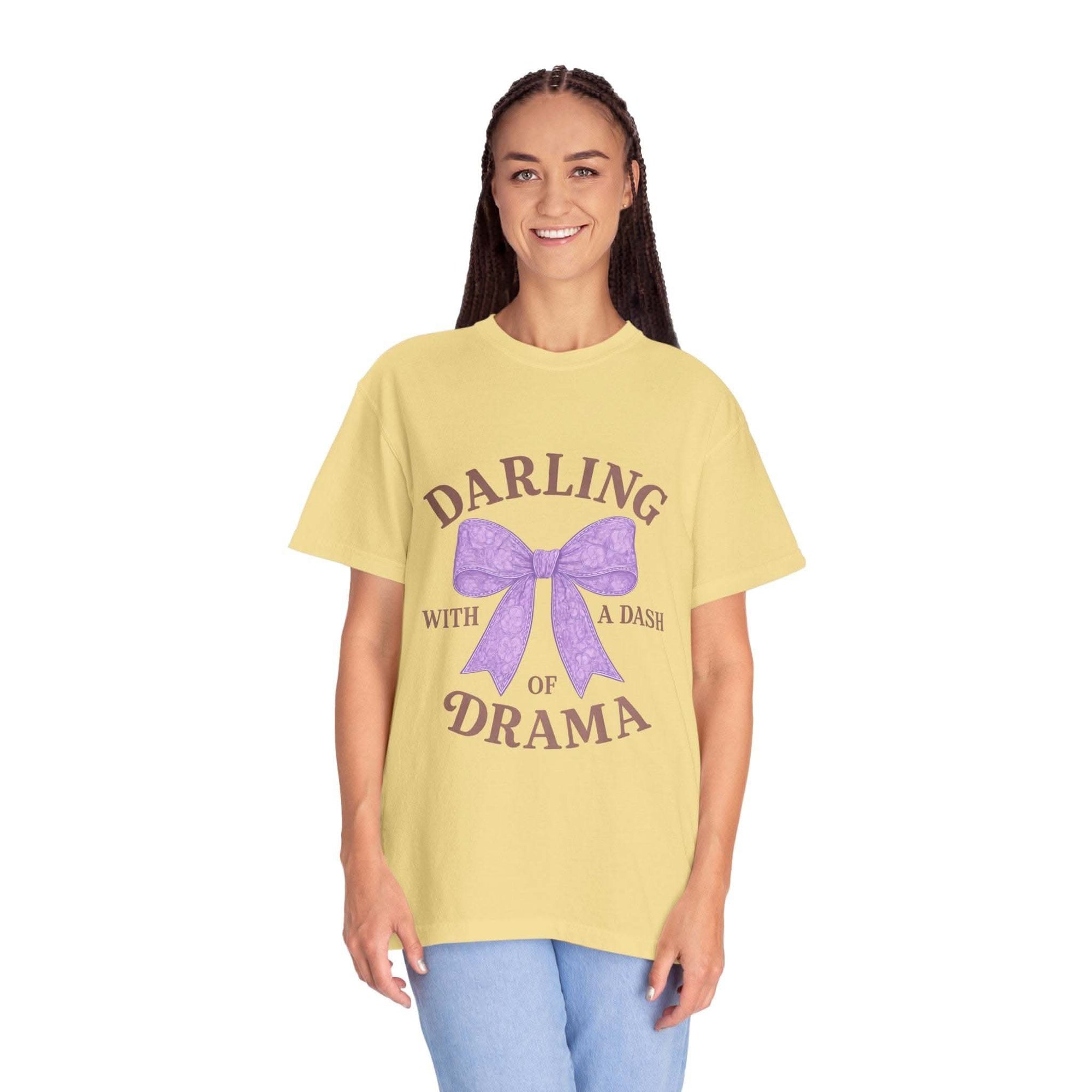 Woman wearing a yellow t-shirt with a purple bow and text on a white background