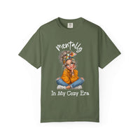 Mentally in my Cozy Era green t-shirt with graphic of a girl sitting cross-legged wearing glasses and a headband