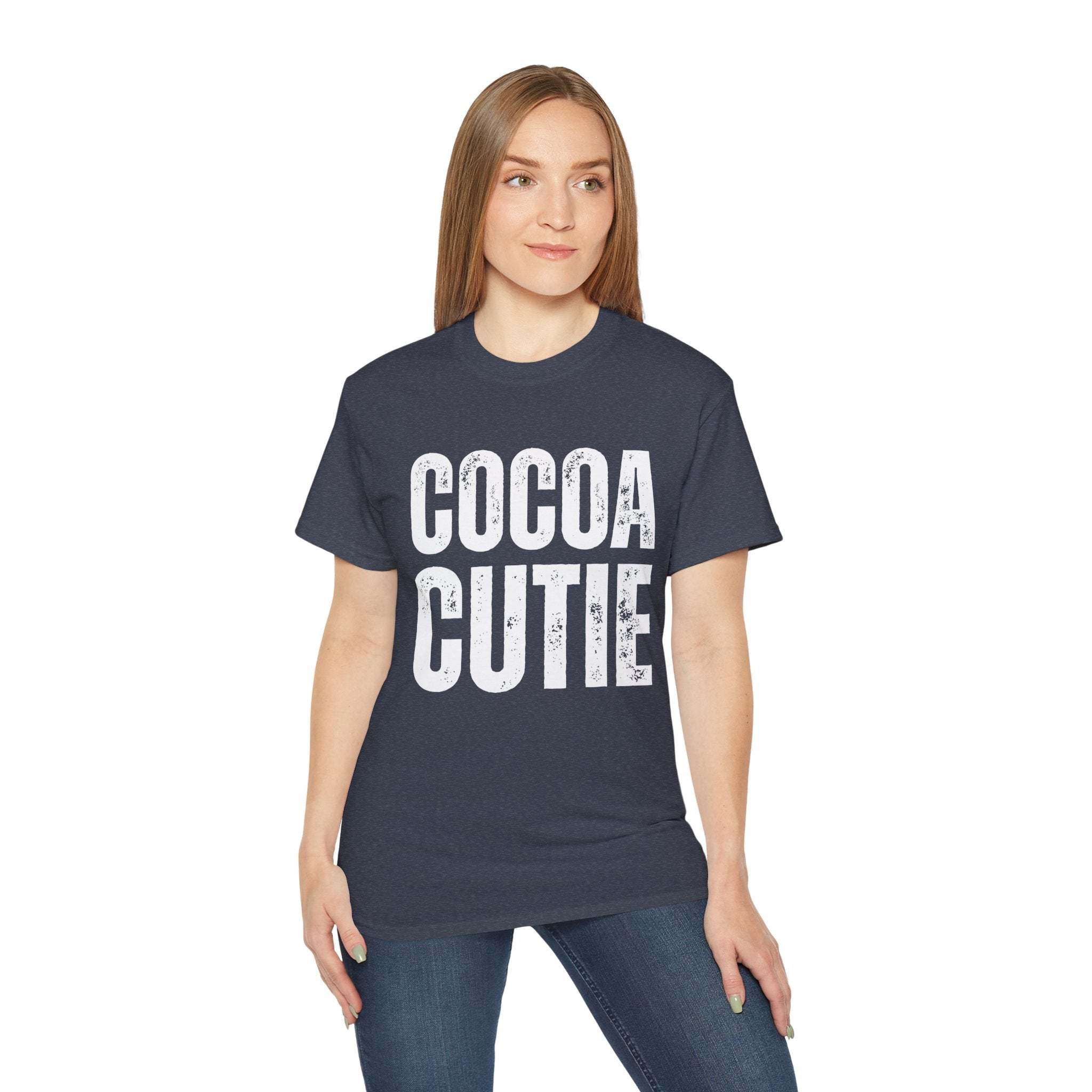 Woman wearing distressed Cocoa Cutie Tee with white text on navy blue shirt