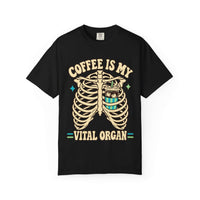 A black short-sleeve crewneck t-shirt featuring a graphic print of a rib cage with a coffee cup inside, and the text 'COFFEE IS MY VITAL ORGAN' in a beige retro font.