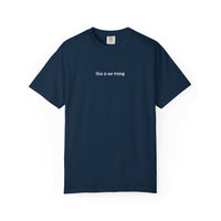 Navy blue t-shirt with 'this is me trying' text on a white background