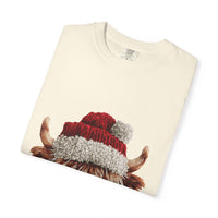 Cream T-shirt with faux crochet yarn highland cow wearing Santa hat print