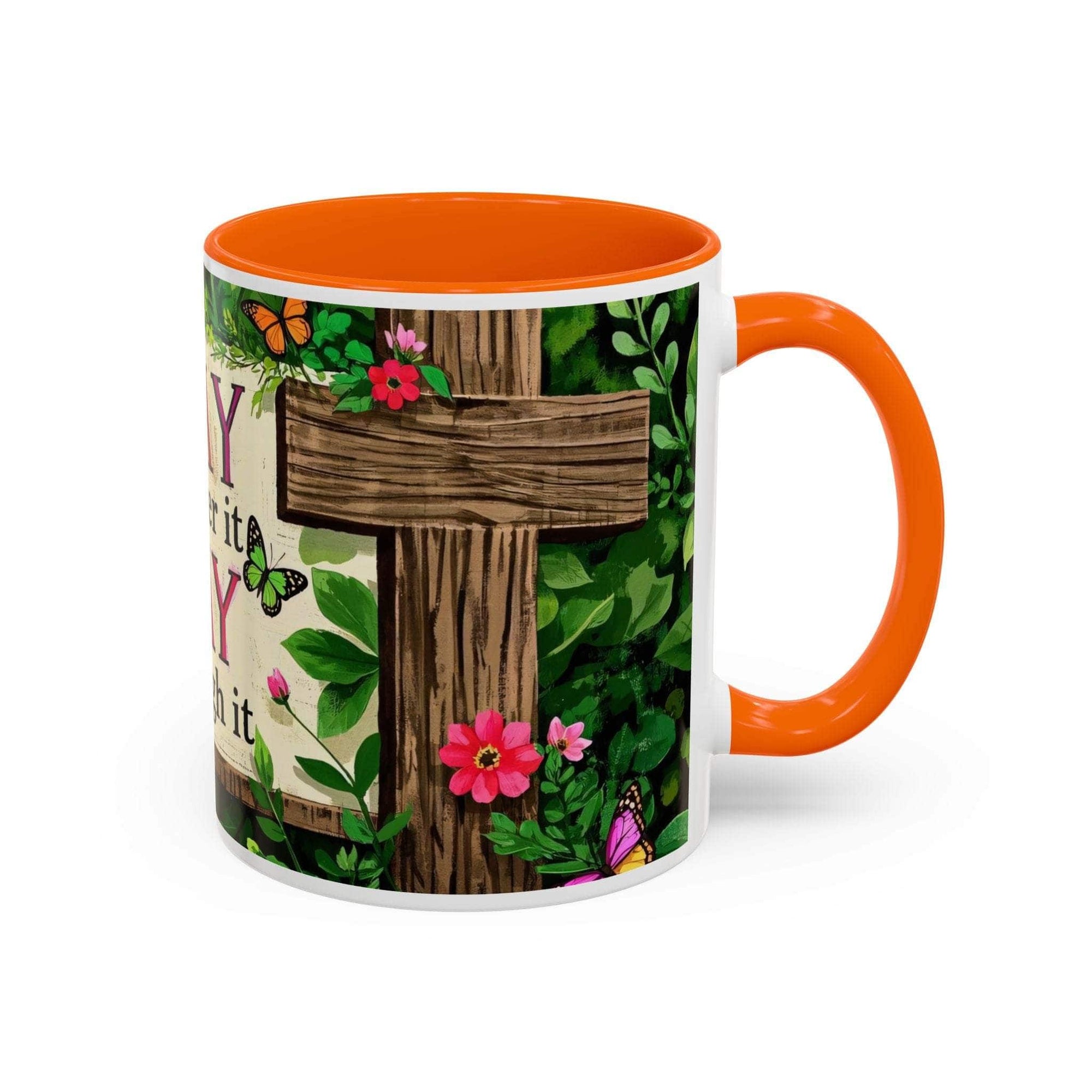 Mug with orange interior and handle, featuring a wooden cross and floral design on a white background