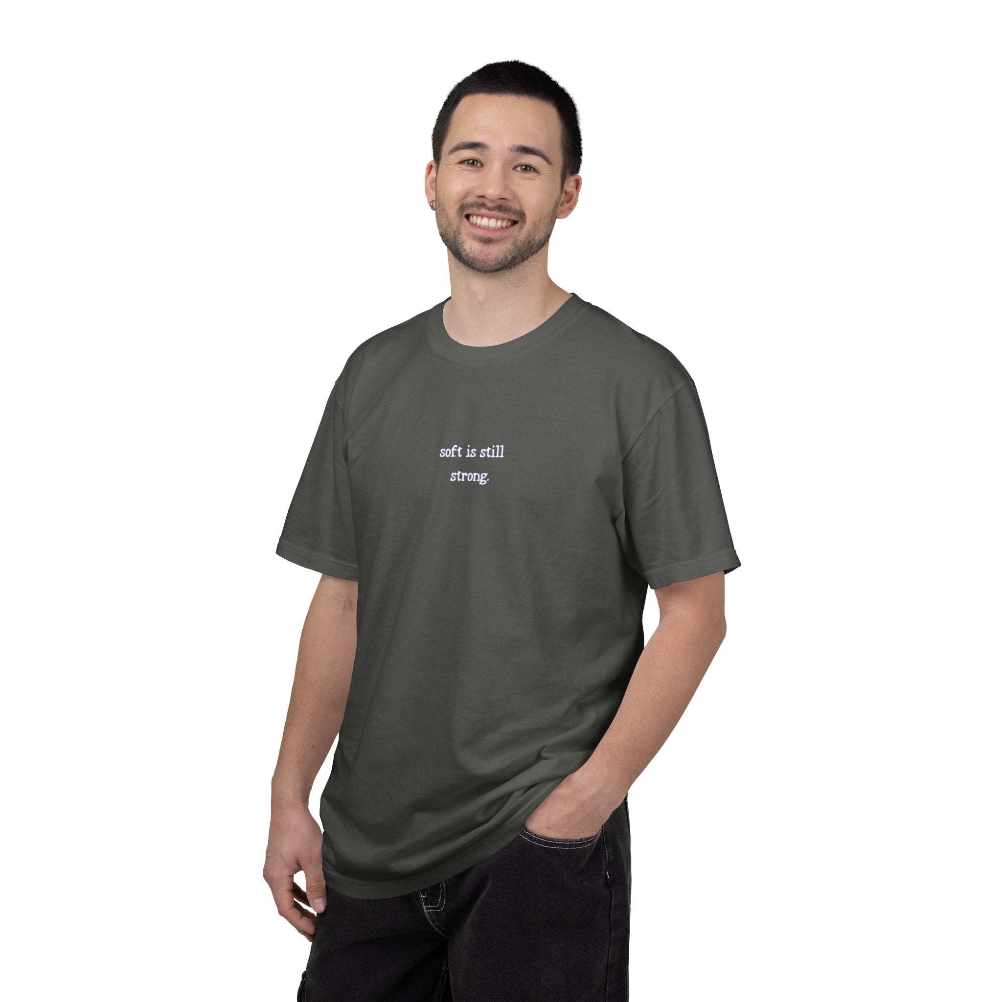 Man wearing a dark gray t-shirt with text on a white background