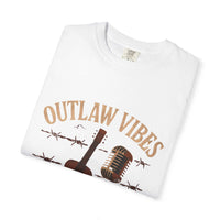 White t-shirt with 'Outlaw Vibes' text and guitar graphic on a white background