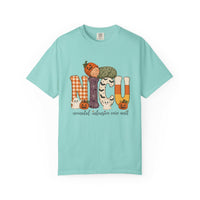 Chalky mint NICU nurse Halloween T-shirt with patchwork lettering, a sleeping baby in a pumpkin hat, ghosts, and jack-o’-lanterns.