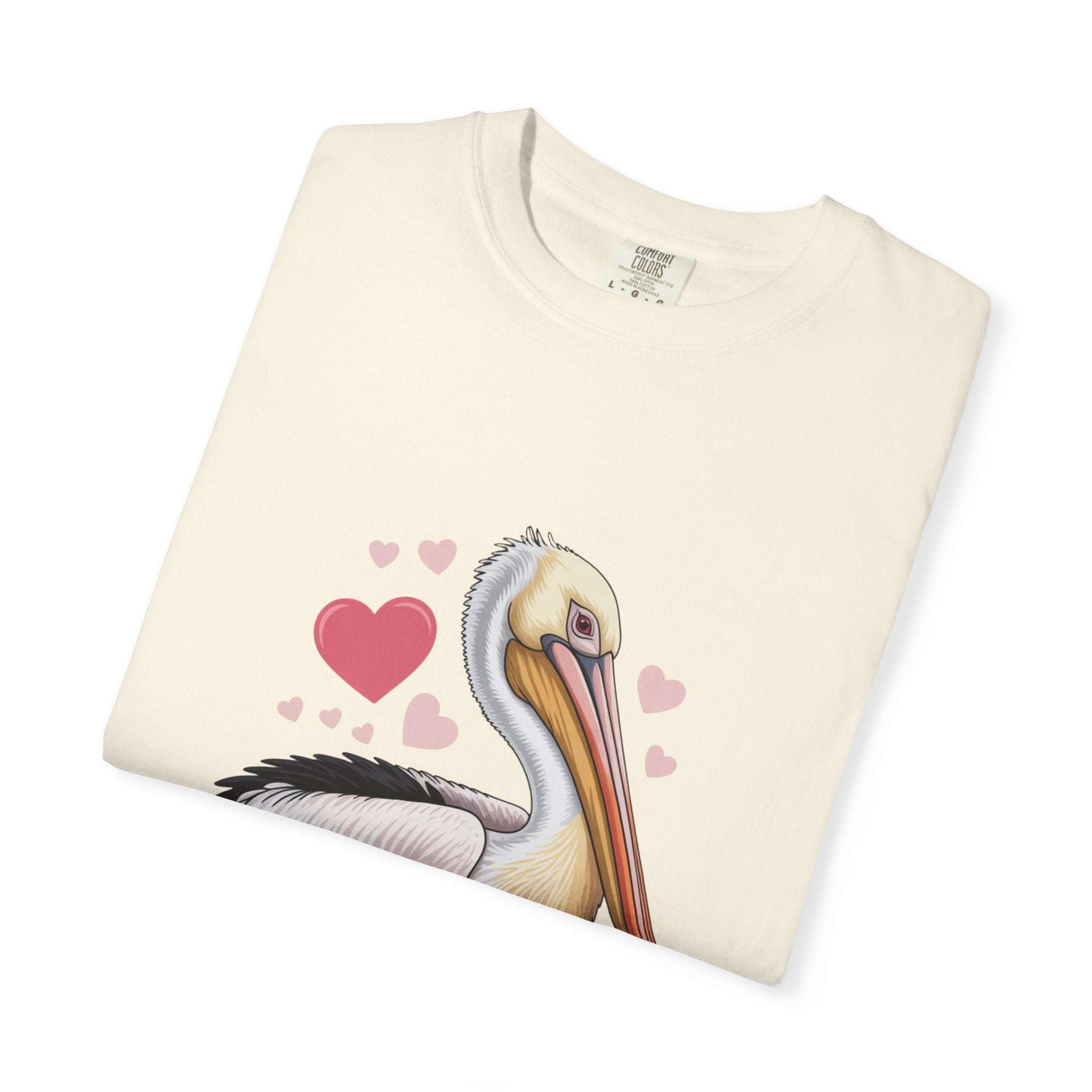 Valentine Pelican Hearts T-Shirt with pelican carrying heart on sunlit shoreline