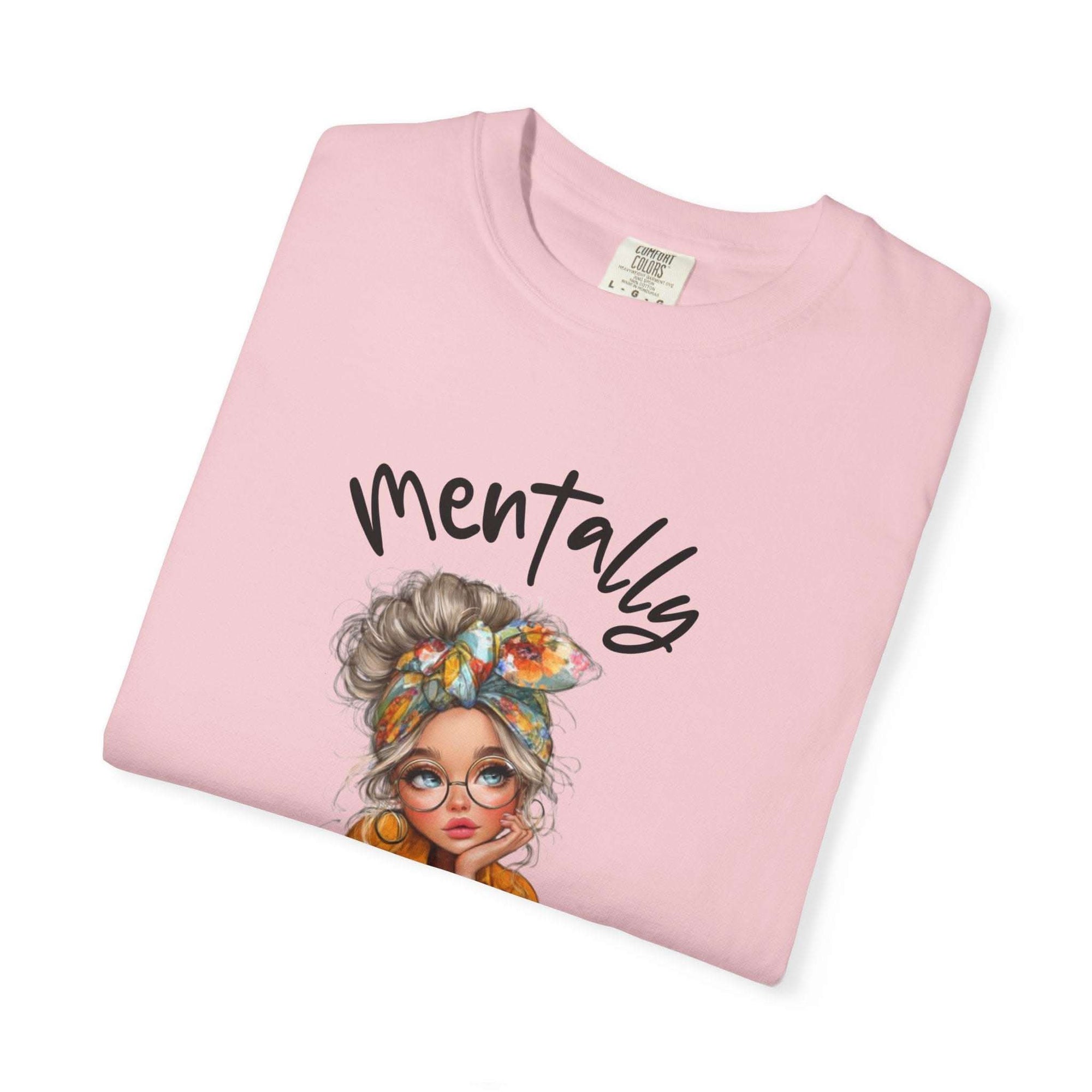 Pink Mentally in My Cozy Era T-shirt with hand-lettered text and illustrated woman with glasses and a floral headband
