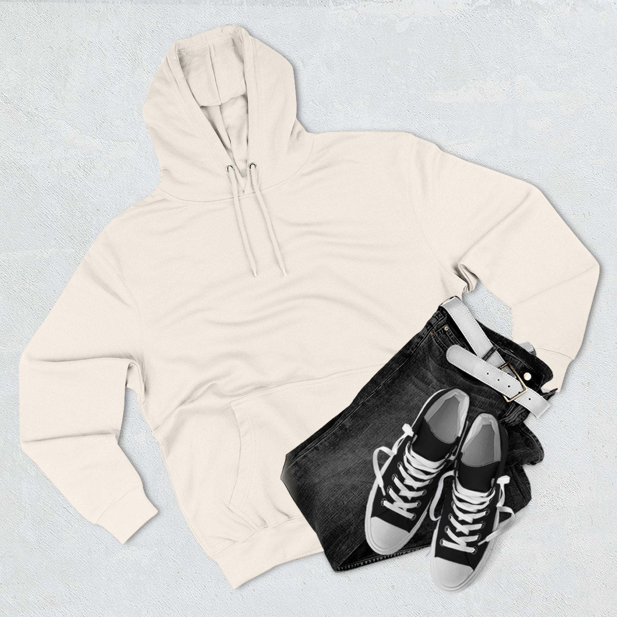White fleece hoodie with black jeans and sneakers flat lay on gray background