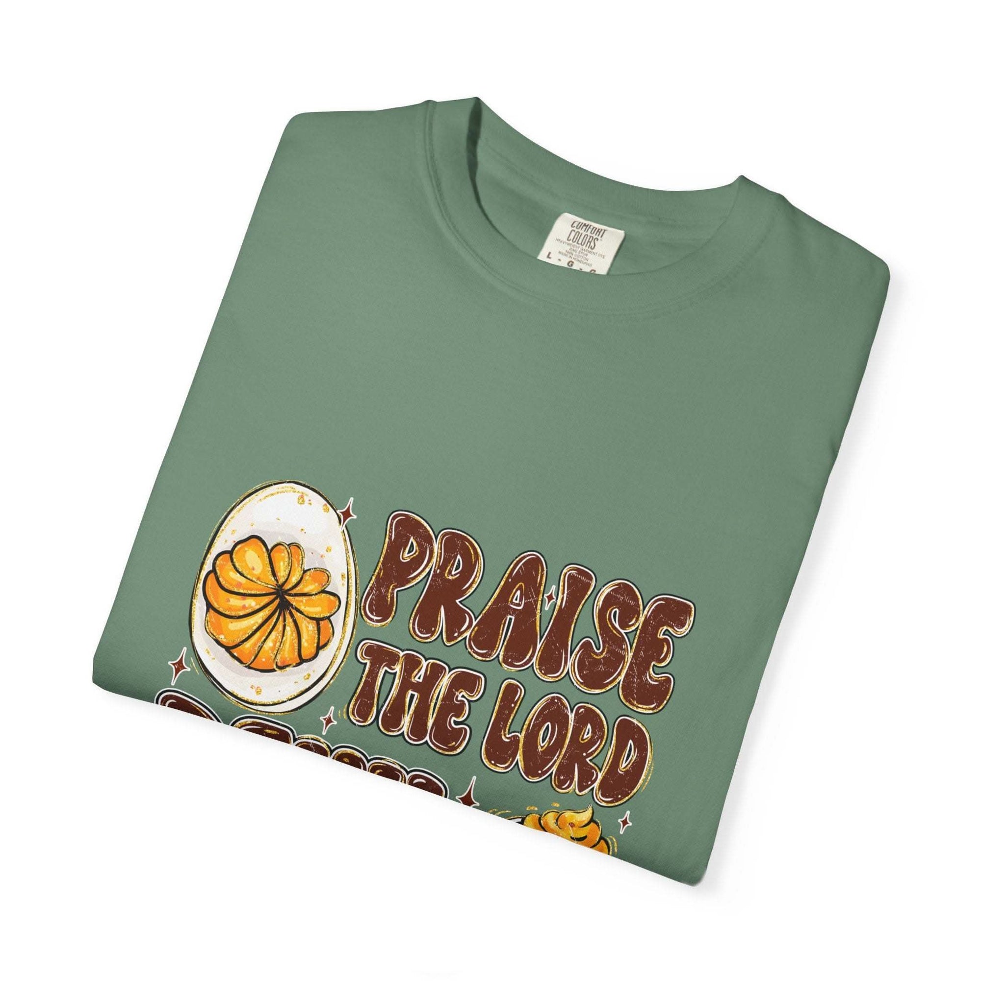 White cotton t-shirt featuring 'Praise the Lord, Devil the Eggs' design, perfect for Easter and Christian apparel.