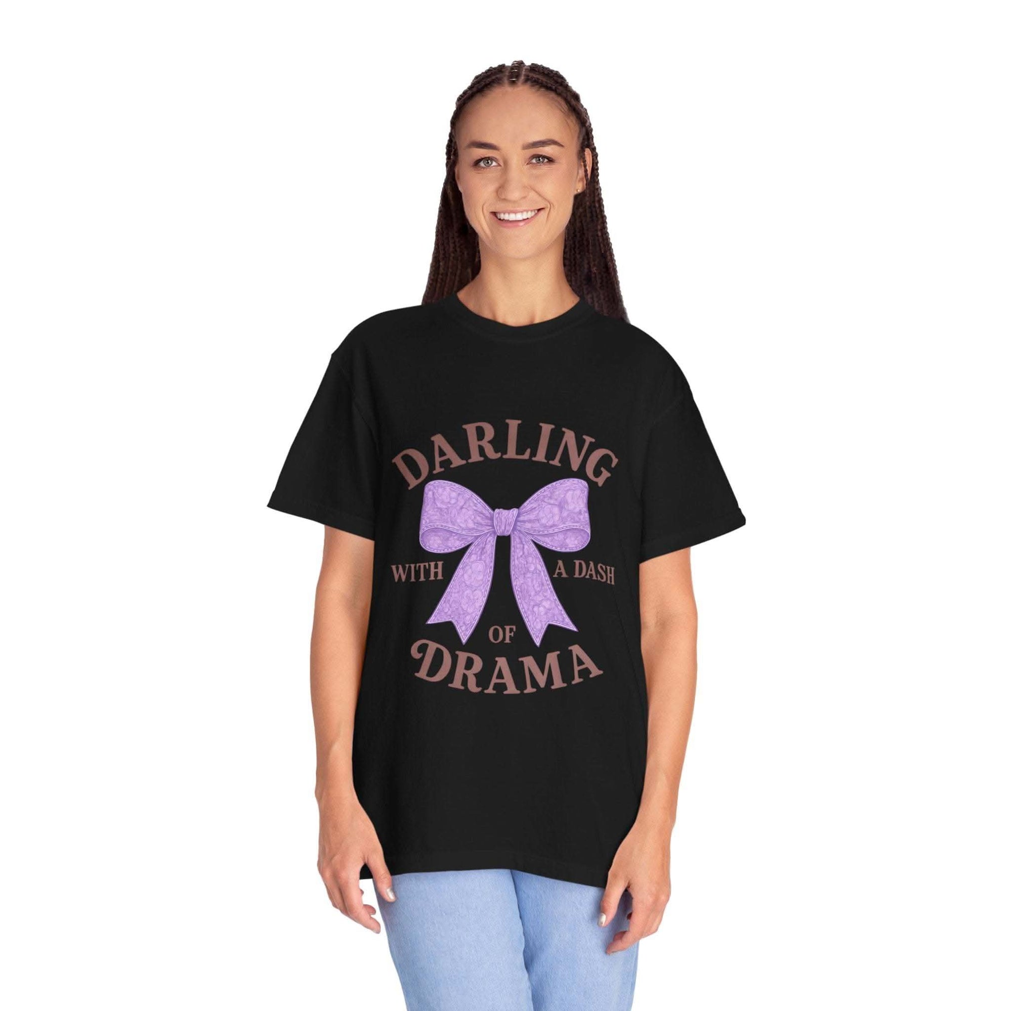Person wearing a black t-shirt with a purple bow graphic and text on a white background