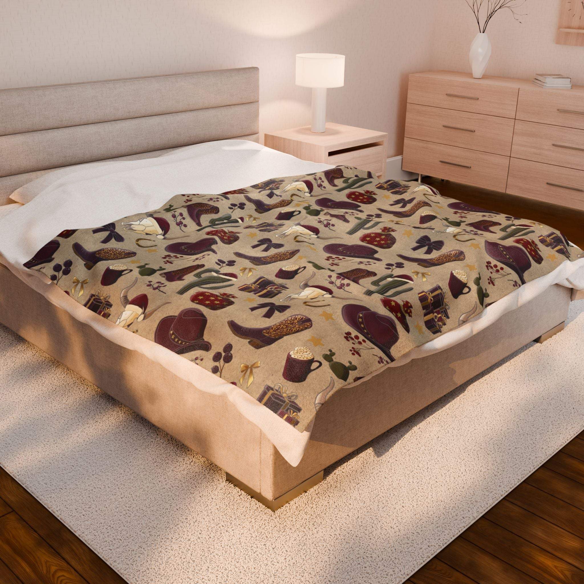 Cozy plush blanket with cowboy Christmas design featuring boots, hats, and festive elements on bed in modern bedroom