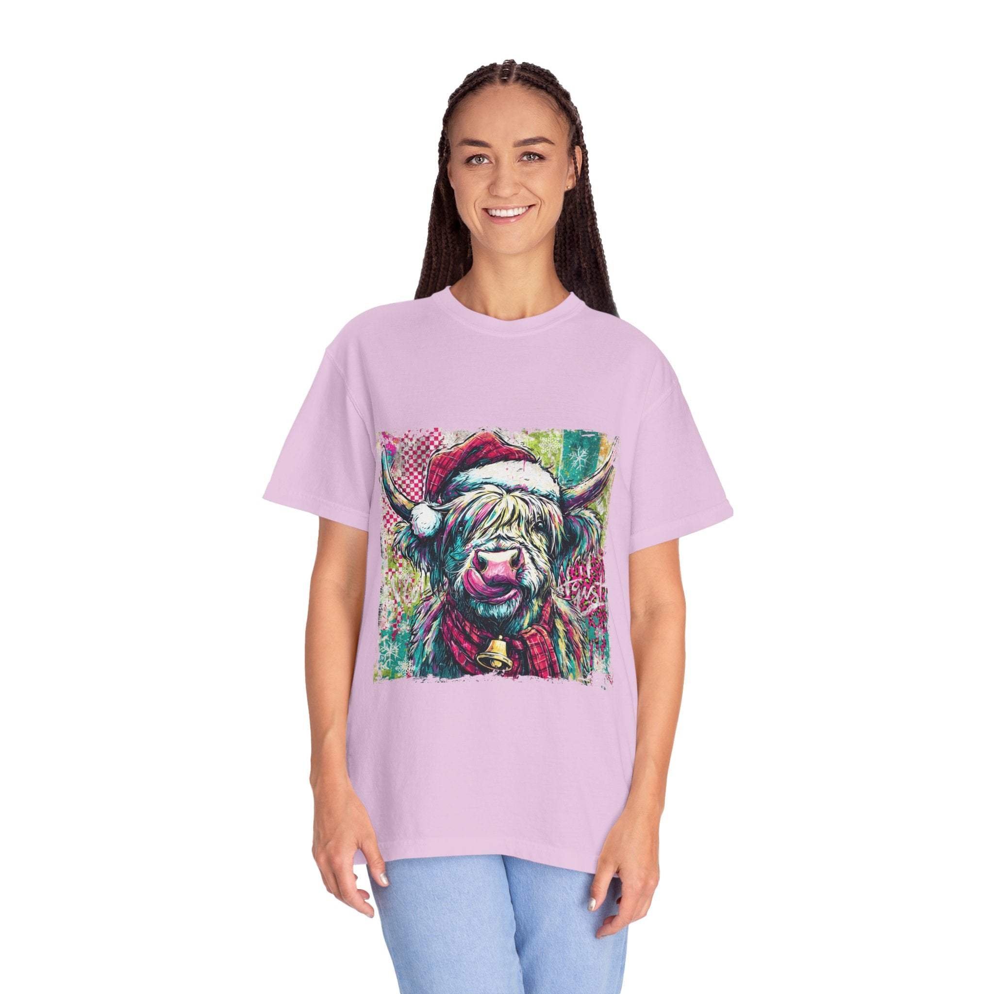 Woman wearing a retro Santa Highland Cow T-shirt in light purple with holiday-themed cow graphic