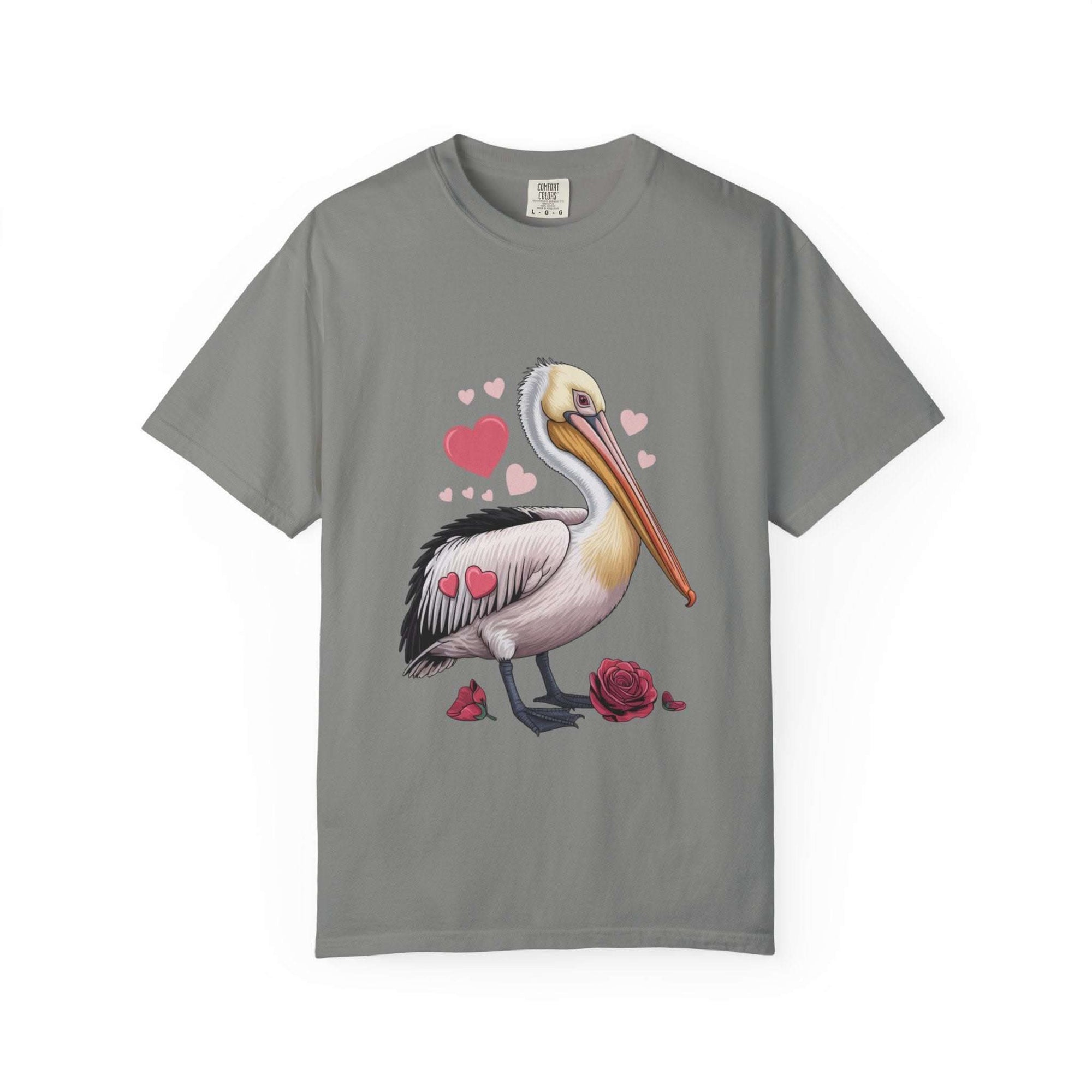 Valentine Pelican Hearts T-Shirt with pelican carrying heart on sunlit shoreline in soft garment-dyed cotton