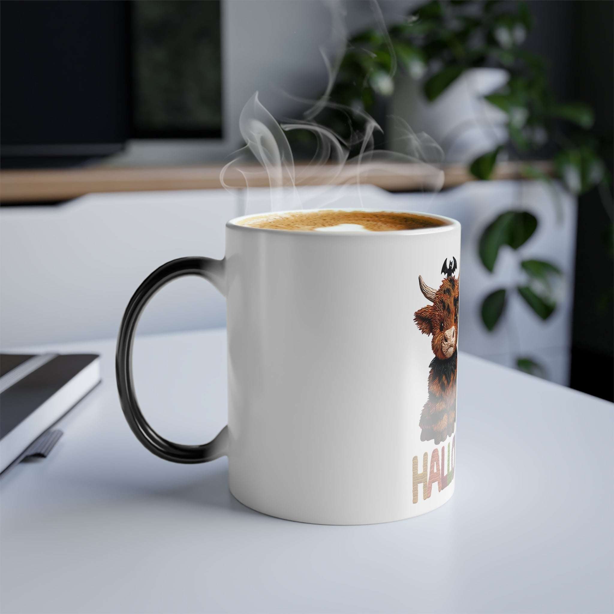 Steaming mug with a cow design on a desk