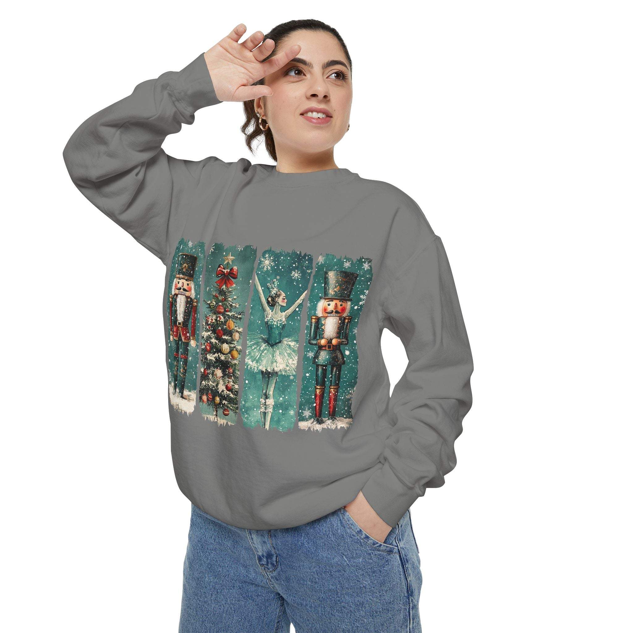 Woman wearing vintage Christmas Nutcracker watercolor sweatshirt with nutcracker, Christmas tree, and ballerina designs.