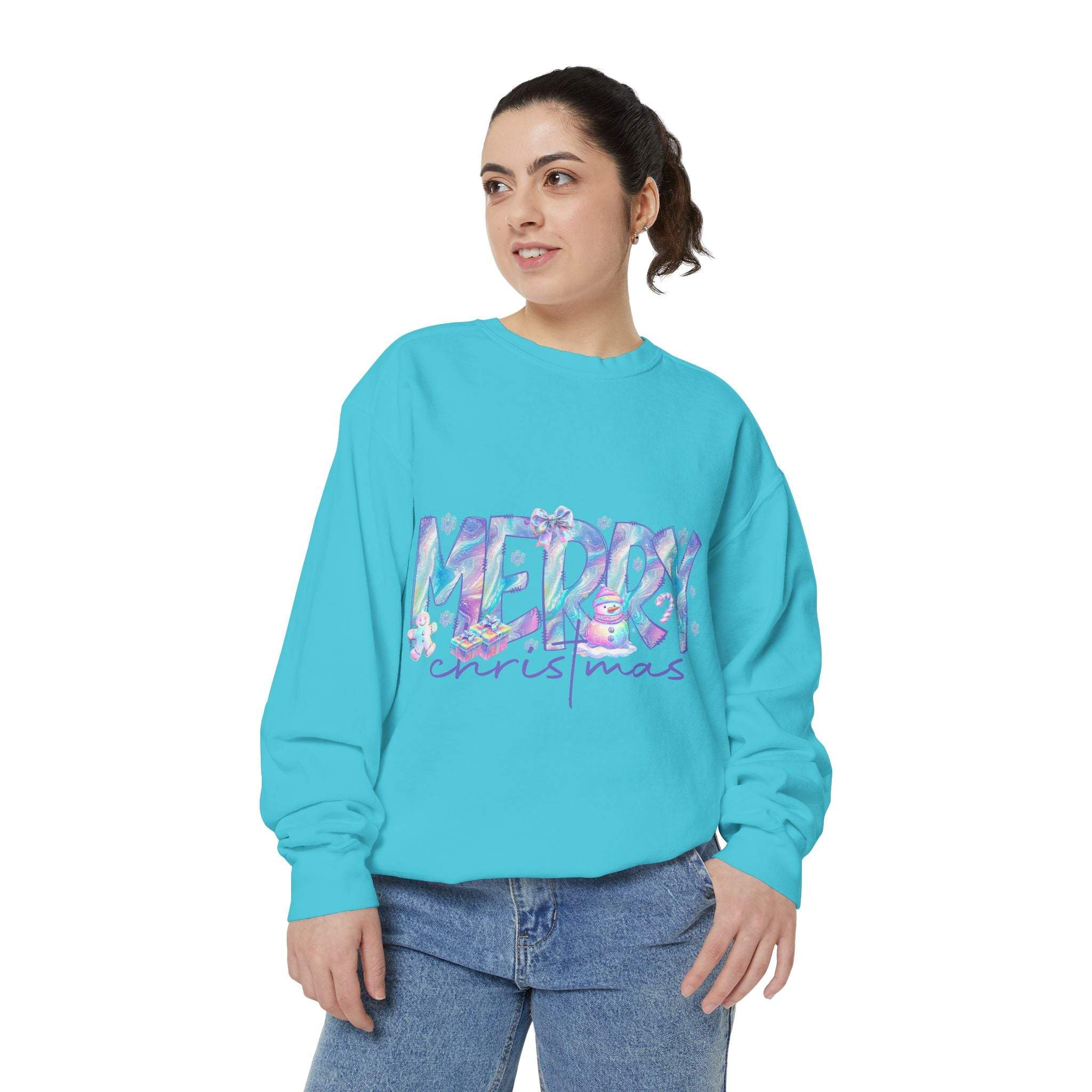 woman wearing iridescent merry christmas sweatshirt in bright blue holiday apparel