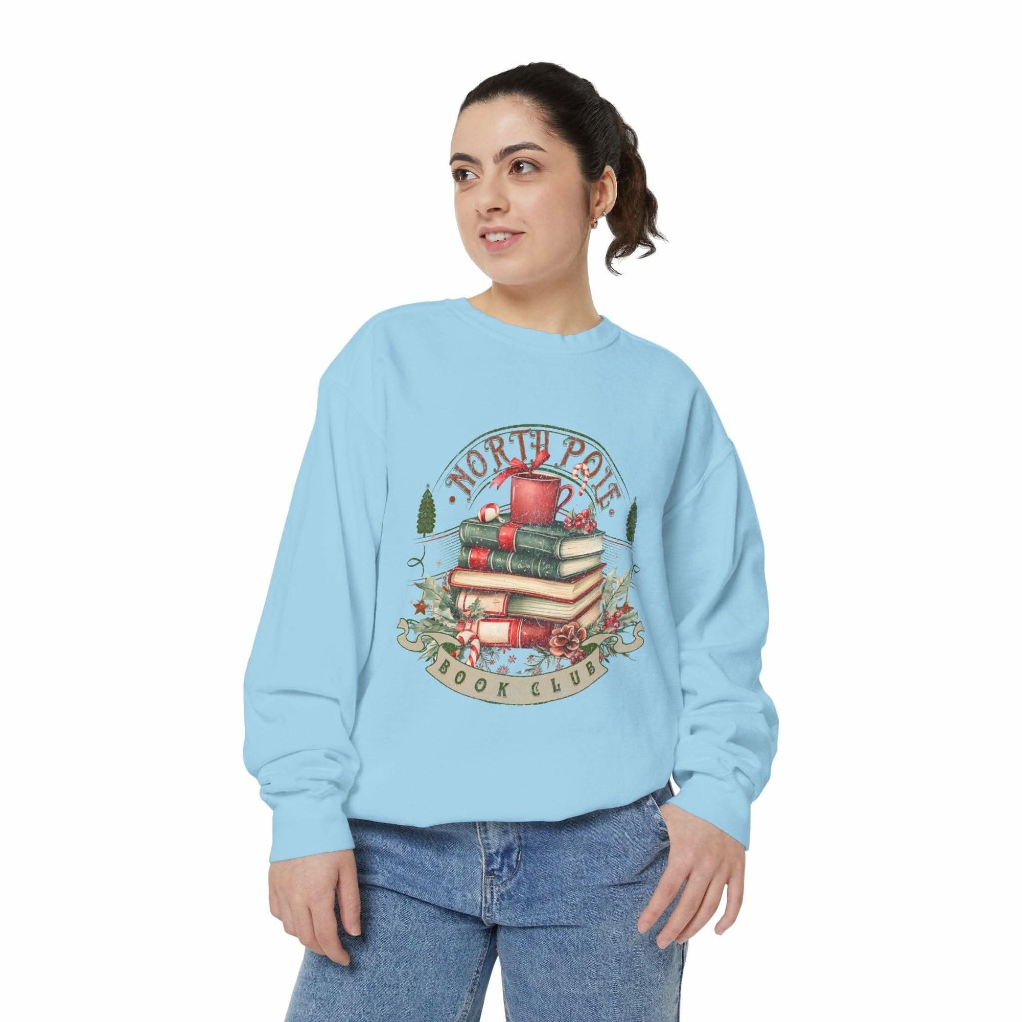 Woman wearing light blue Vintage North Pole Book Club sweatshirt with holiday book stack design
