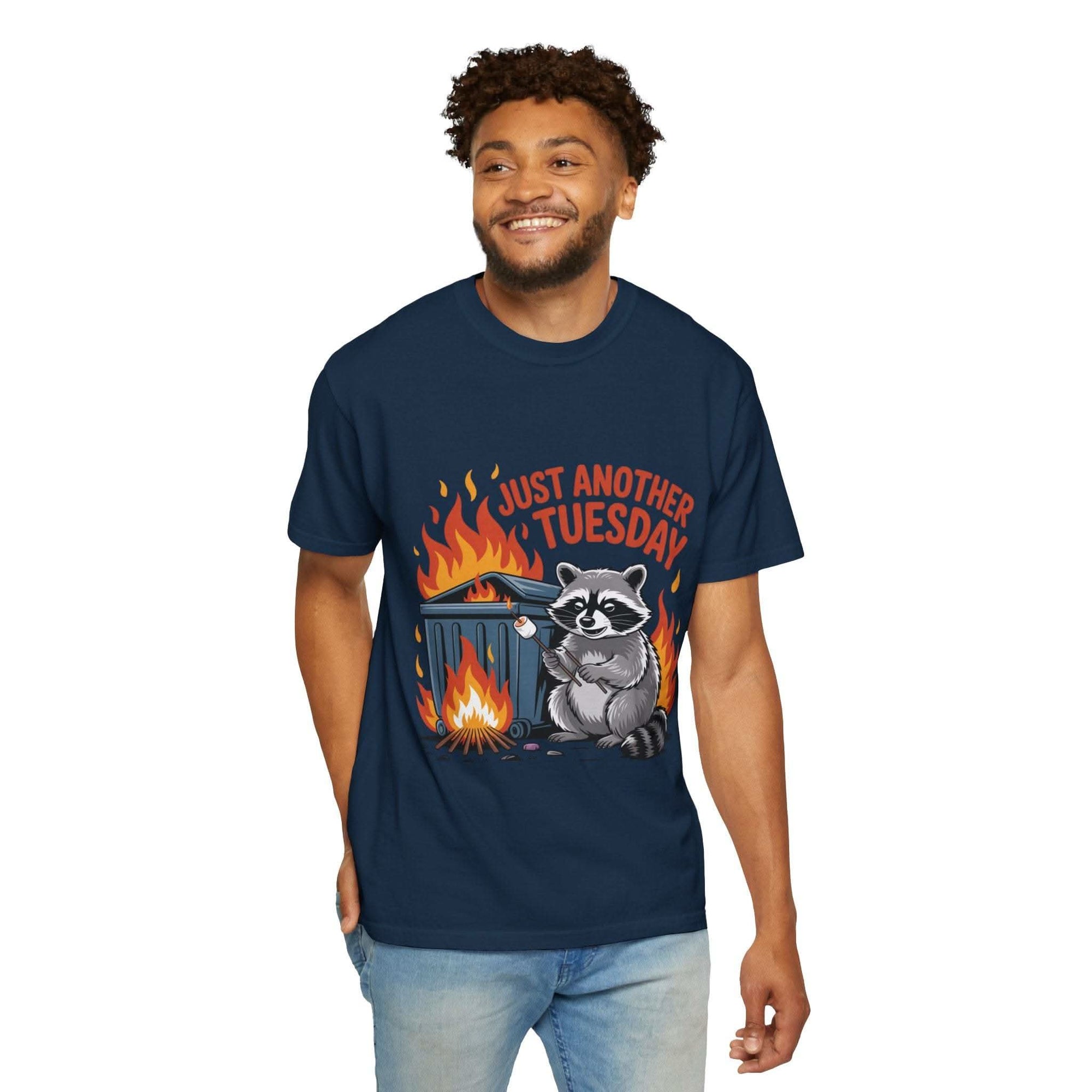 Navy t-shirt with raccoon and dumpster fire graphic captioned Just Another Tuesday, dark humor design, relaxed fit