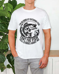 Fishing T-Shirt with humorous "So Good At Catching Fish That The Fish Tell Stories About Me" slogan on soft cotton fabric