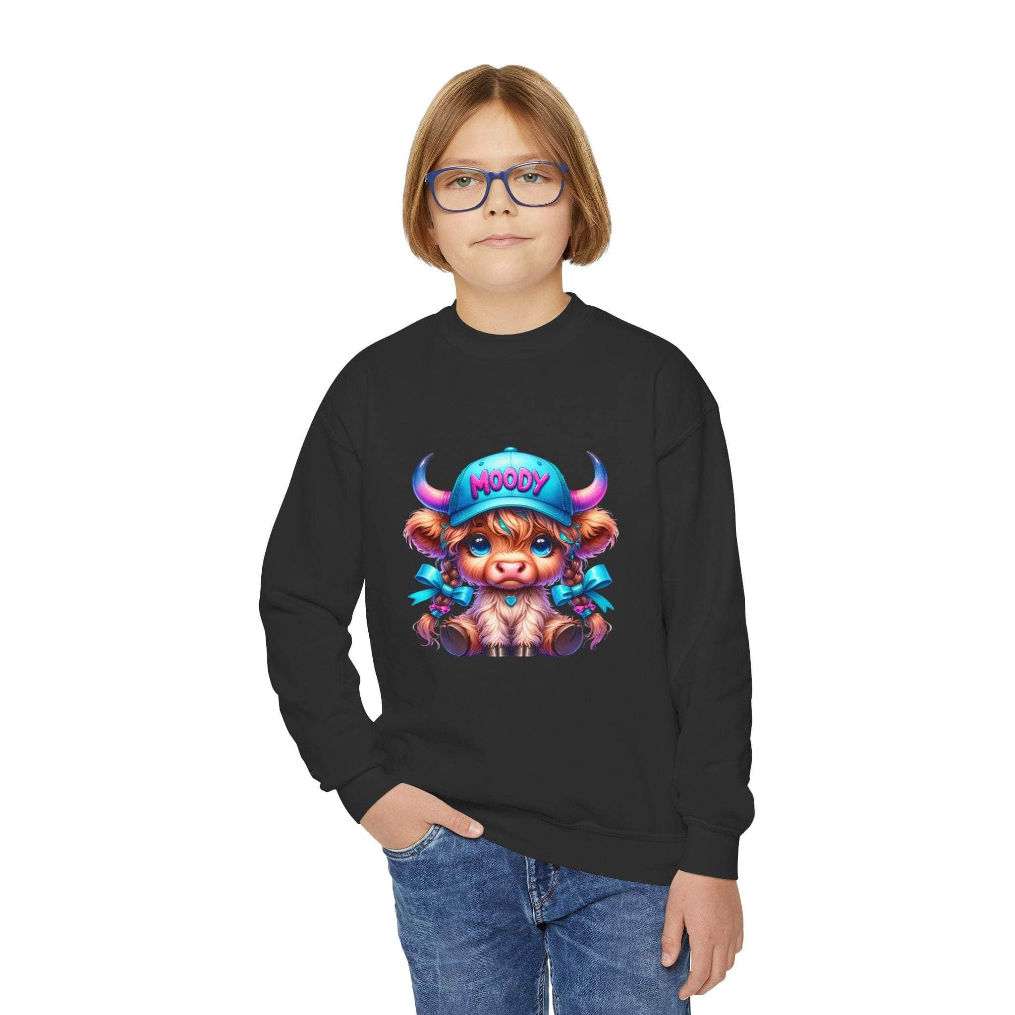 Child wearing black Moody Girl Highland Cow sweatshirt with colorful cartoon cow design and blue jeans