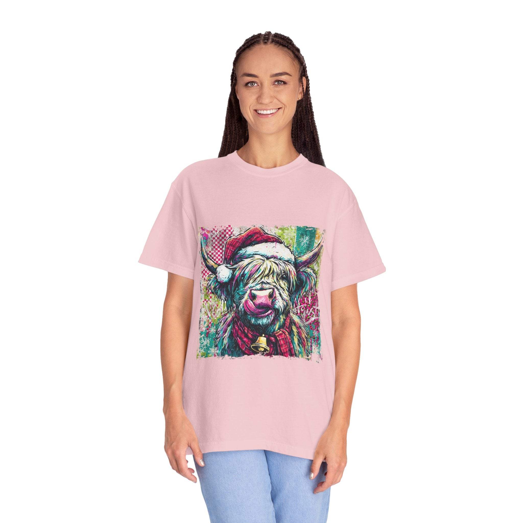 Woman wearing a pink Retro Santa Highland Cow T-shirt with festive design