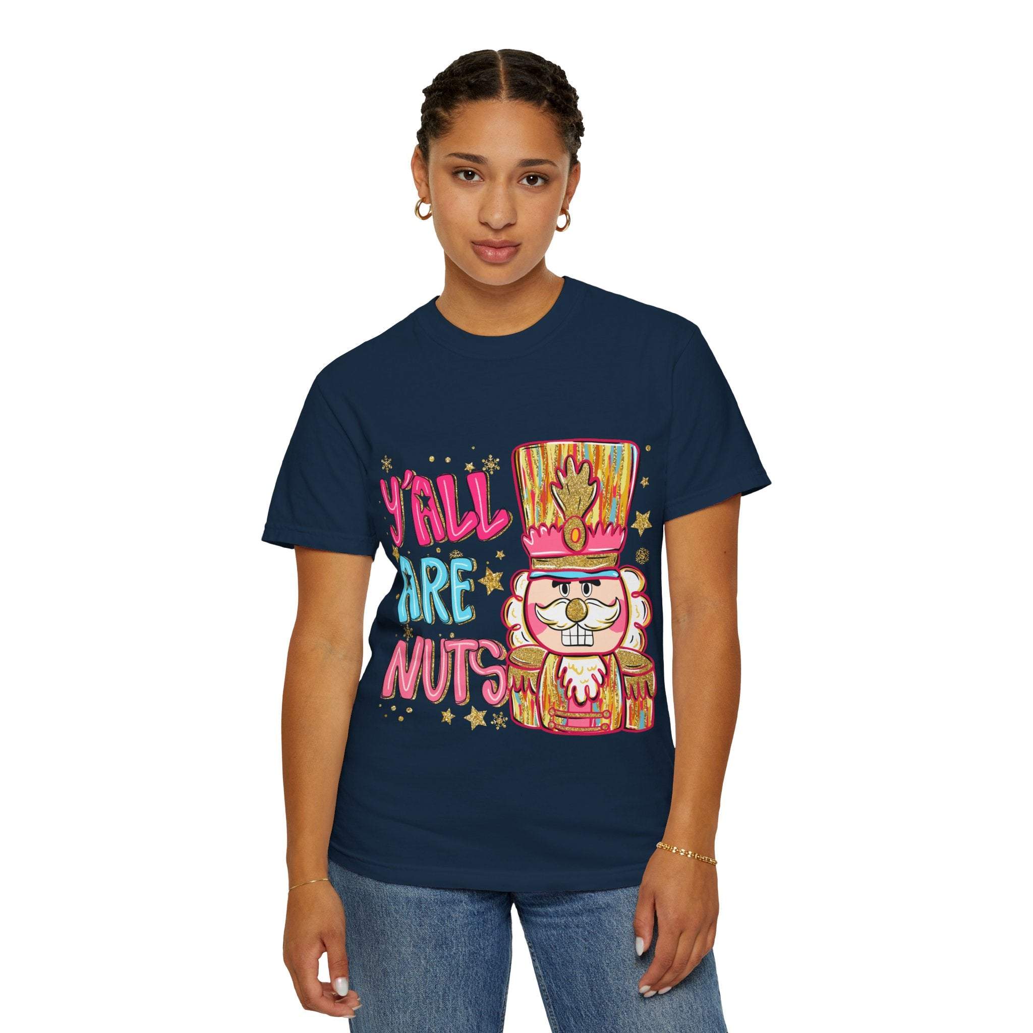 Woman wearing navy Yall Are Nuts Nutcracker T-shirt with colorful nutcracker graphic and text