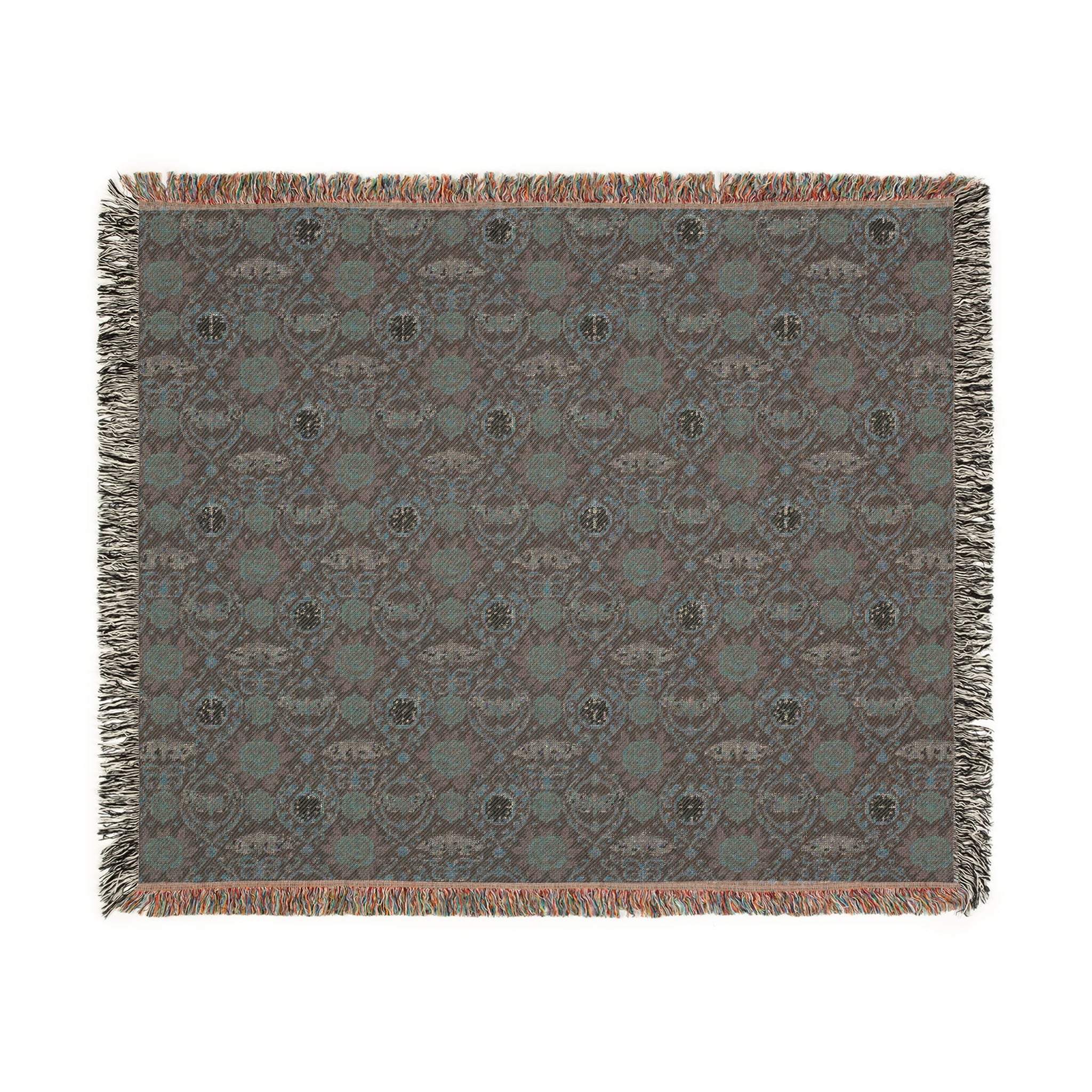 Victorian Gothmas Woven Blanket with candlelight hues and colorful fringed edges draped over dark velvet