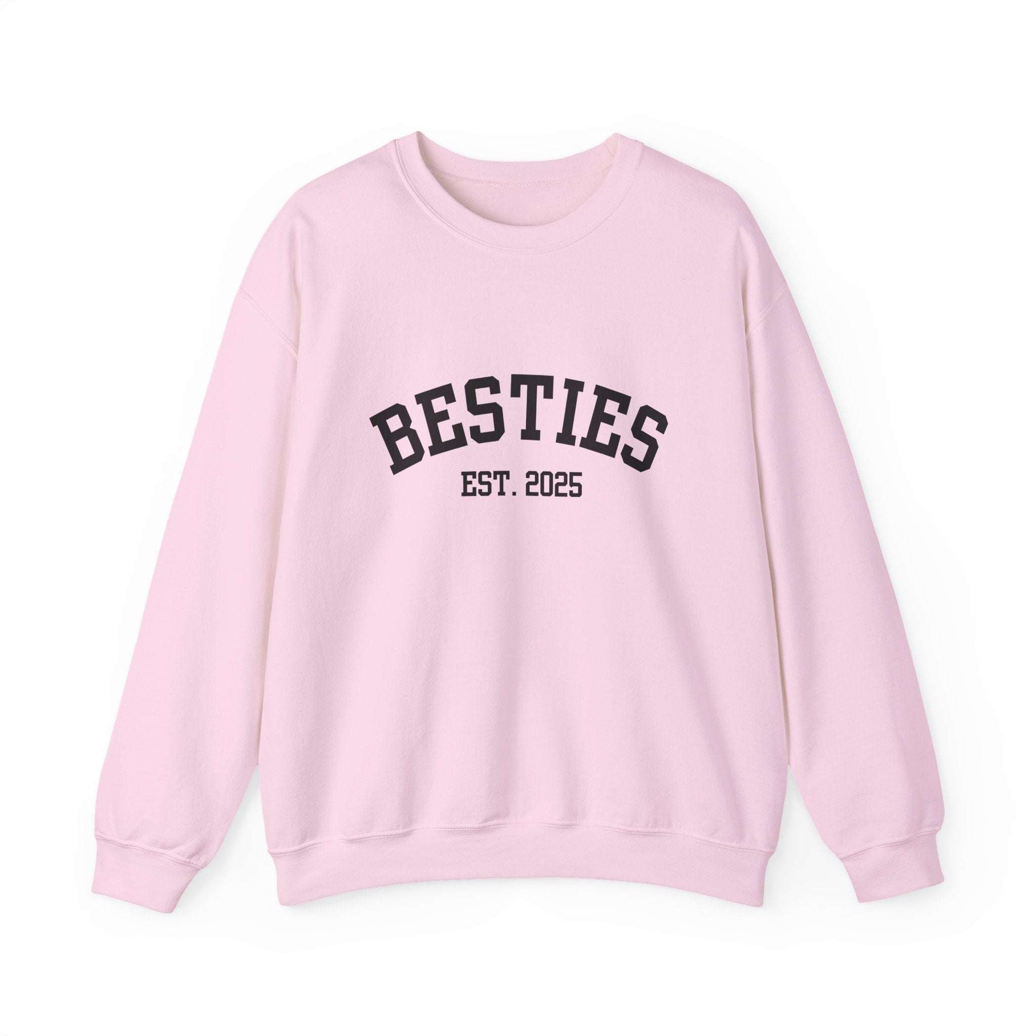 Pink sweatshirt with 'BESTIES EST. 2025' text on a white background