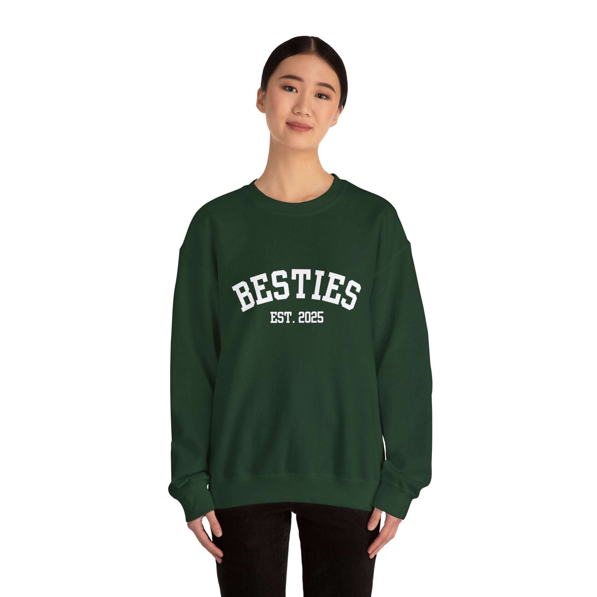 woman wearing green Varsity Besties crewneck sweatshirt with Besties Est. 2025 lettering