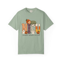Bay green NICU nurse Halloween T-shirt with patchwork lettering, a sleeping baby in a pumpkin hat, ghosts, and jack-o’-lanterns.