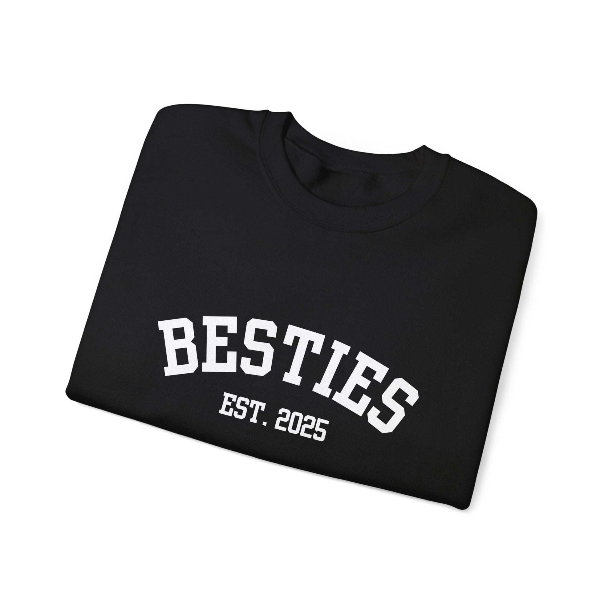 Black t-shirt with 'BESTIES EST. 2025' text on a white background