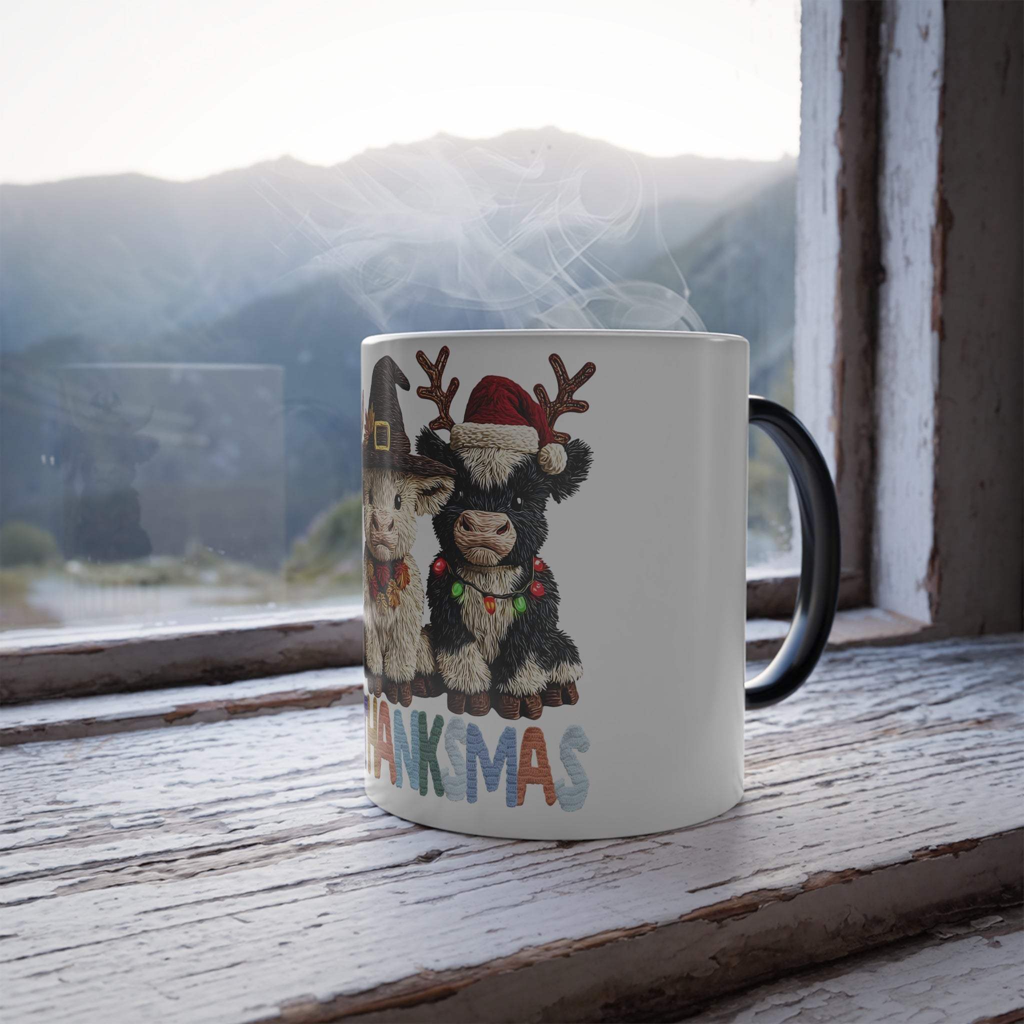 Mug with Christmas-themed design of a donkey and text 'THANKS'MAS' on a wooden surface with a mountain view.