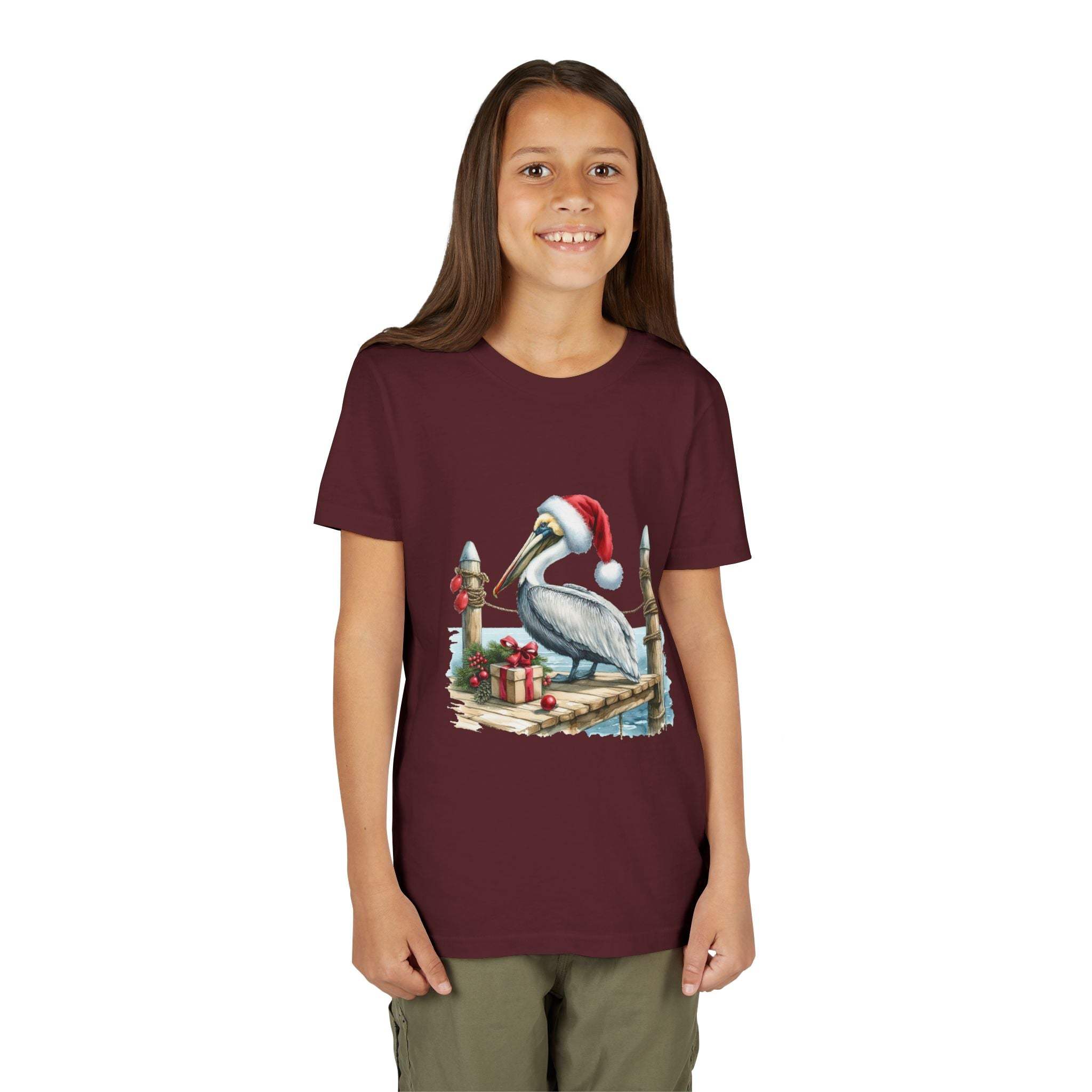 youth wearing maroon Pelican Santa Hat t-shirt with pelican on pier and holiday gifts design