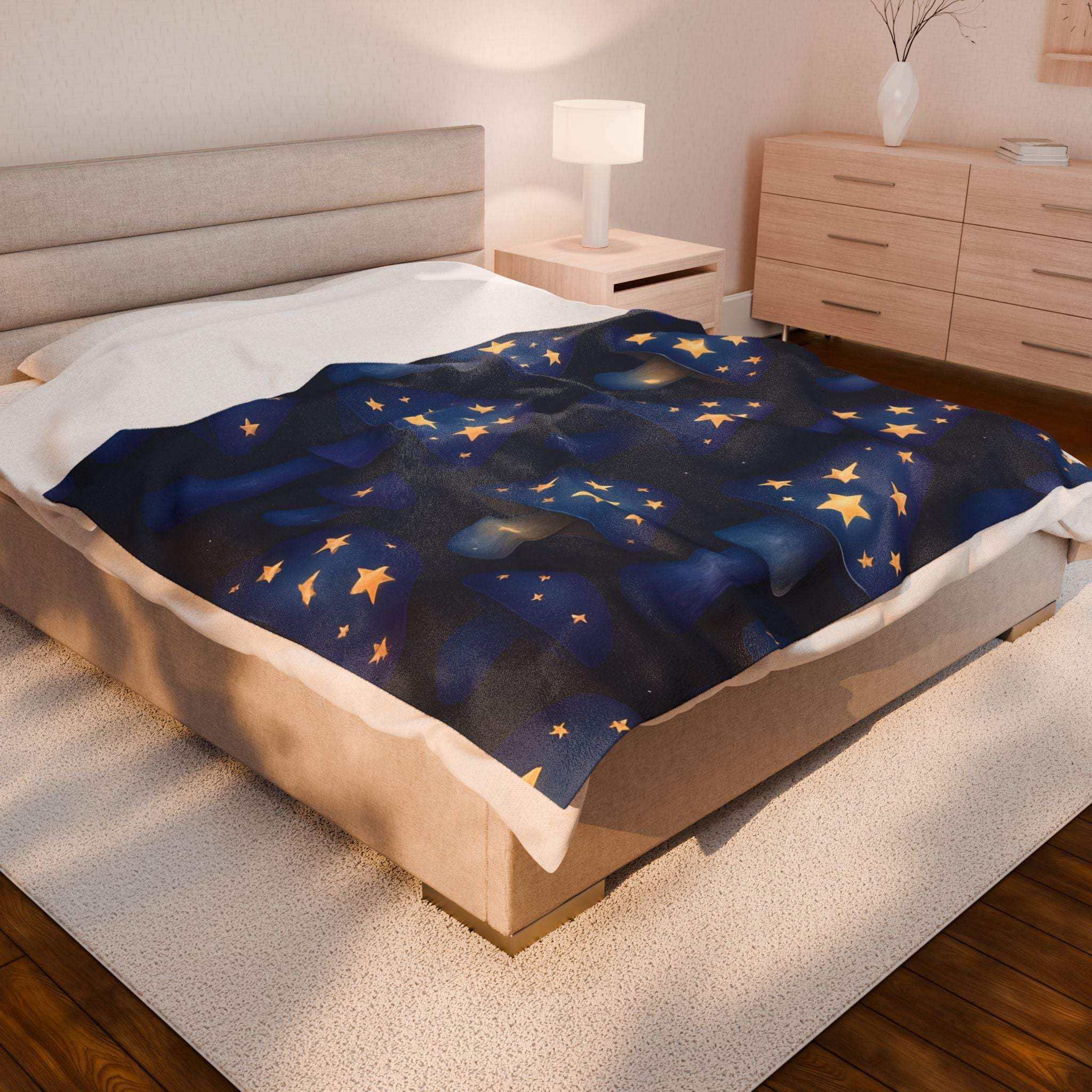 Velveteen plush blanket with whimsical mushrooms and glowing stars on bed in cozy bedroom setting