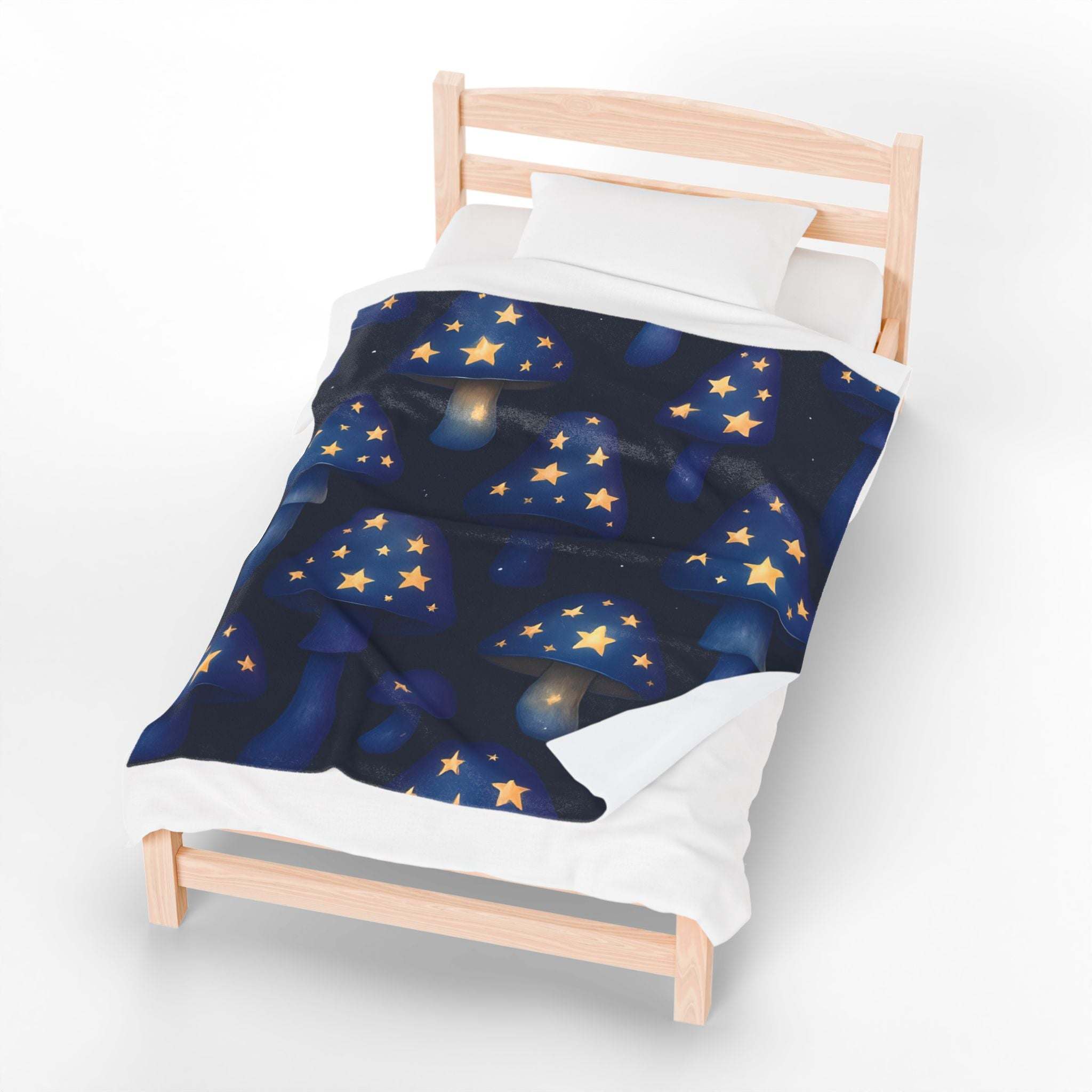 Plush blanket with whimsical glowing star mushrooms design on a dark blue background