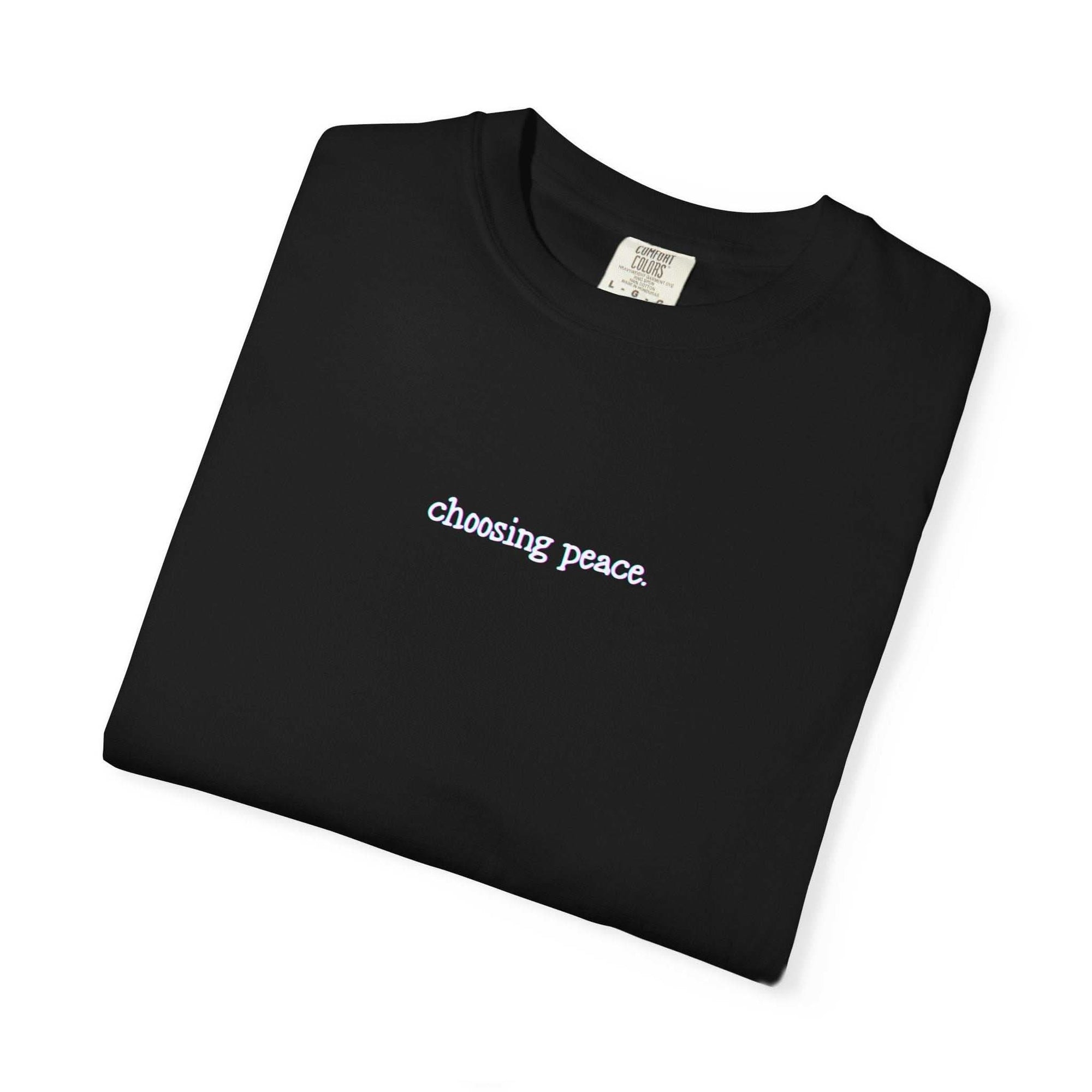 Black t-shirt with 'choosing peace' text on a white background