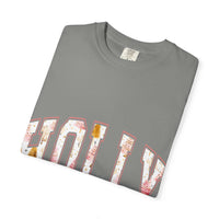 Folded grey Varsity Holly Jolly T-shirt with festive lettering in white and pink holiday designs