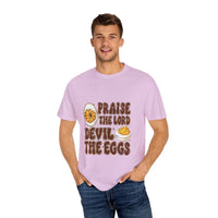 White cotton t-shirt featuring 'Praise the Lord, Devil the Eggs' design, perfect for Easter and Christian apparel.