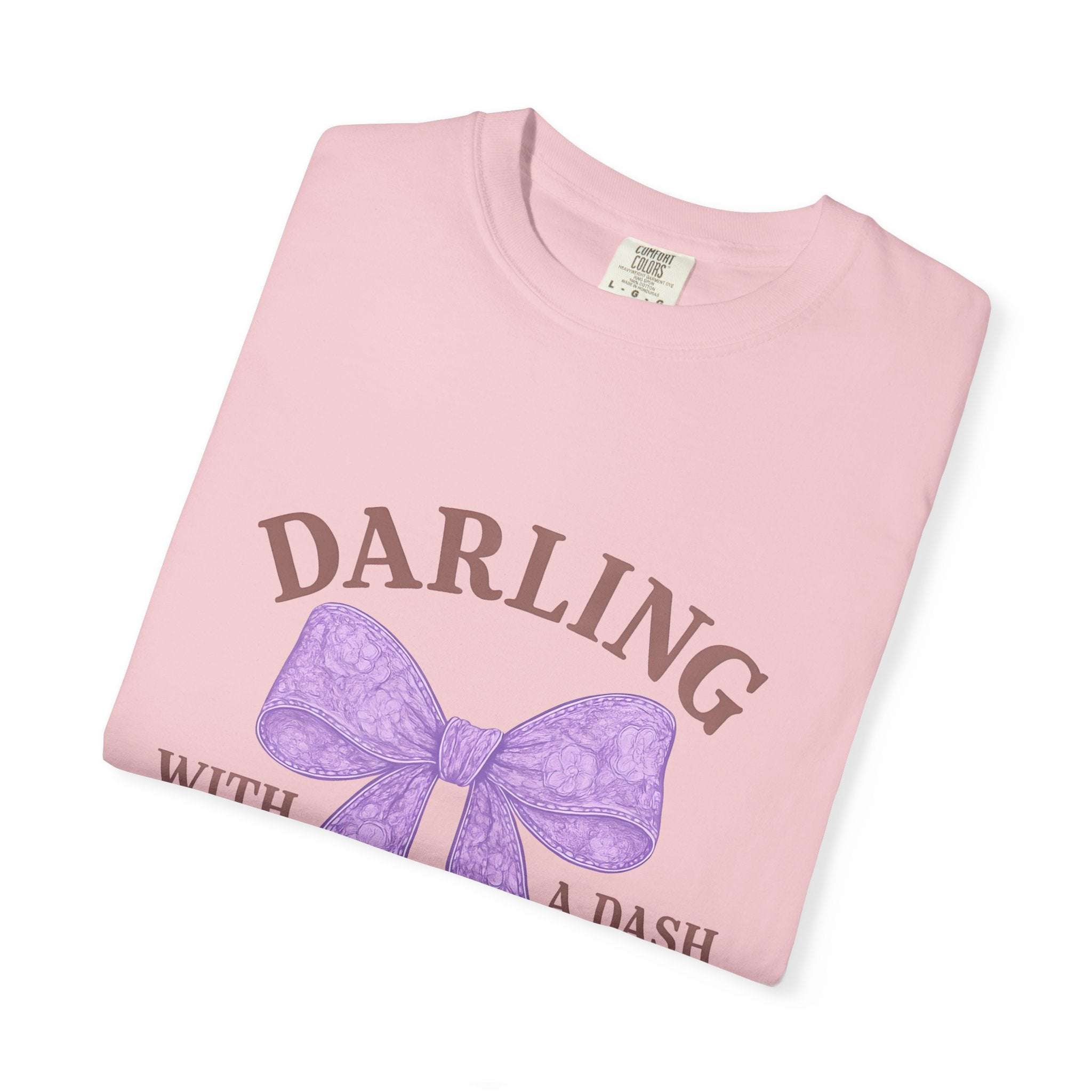 Pink t-shirt with purple bow and text on a white background
