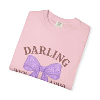 Pink t-shirt with purple bow and text on a white background
