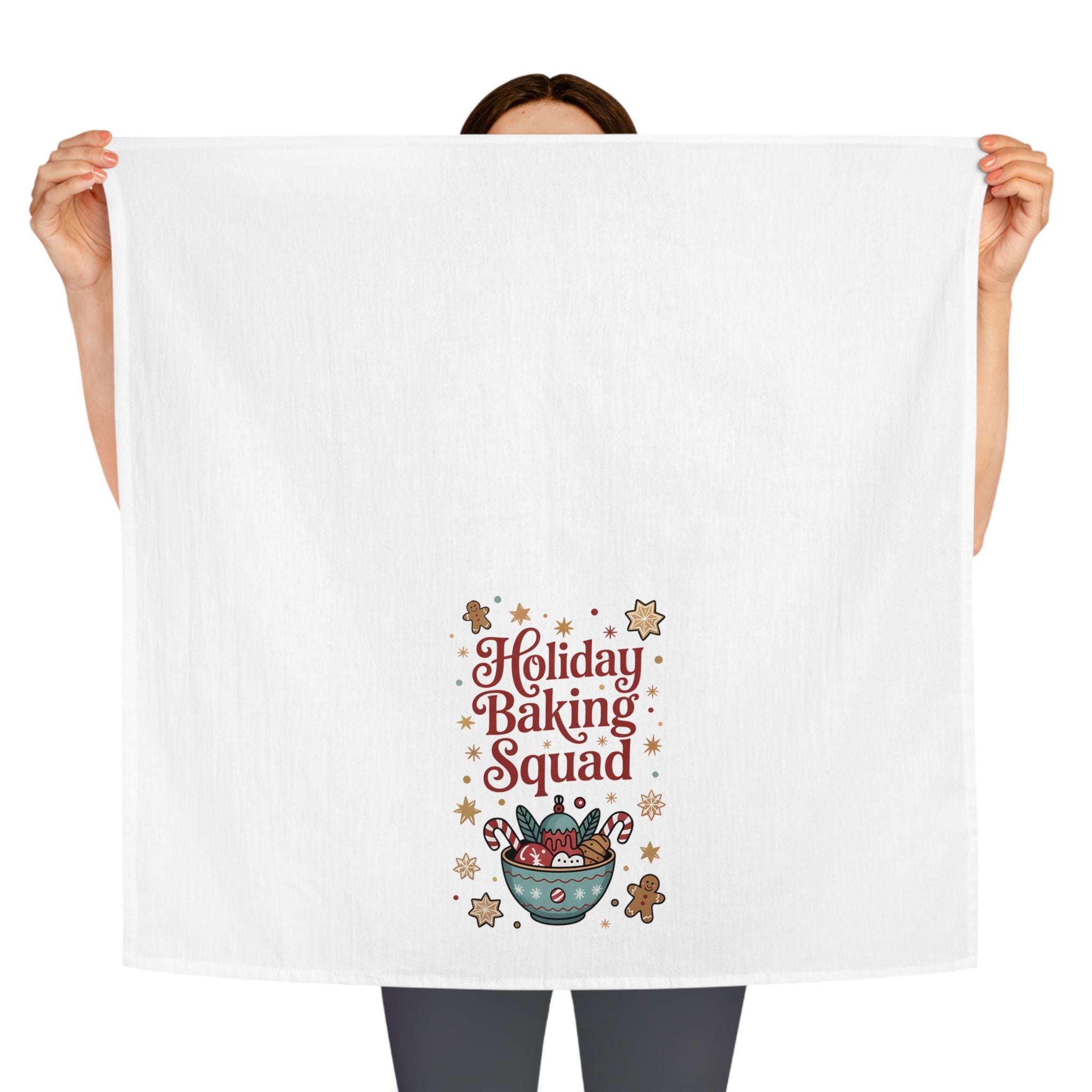 White cotton tea towel featuring 'Holiday Baking Squad' design, perfect for festive kitchen decor.