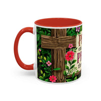 Mug with red interior and handle, featuring a wooden cross design and flowers on a white background.