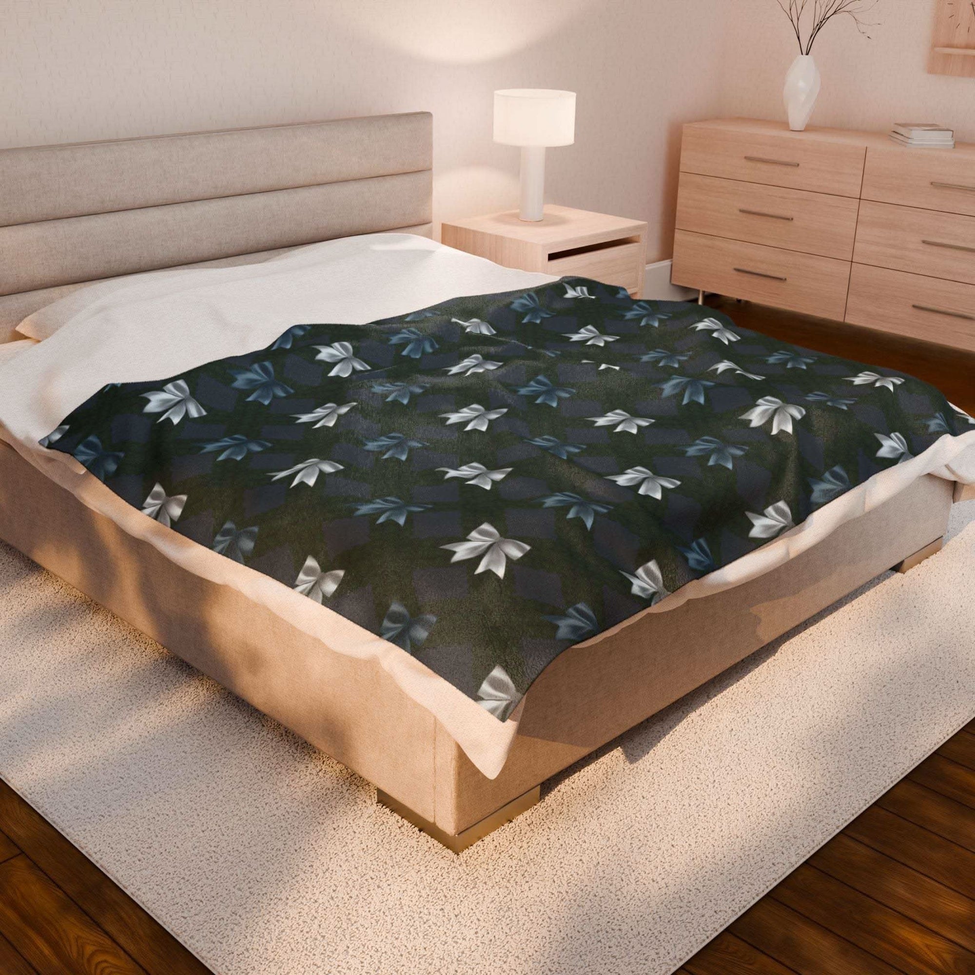Velveteen plush blanket with winter coquette bows design on king bed in cozy bedroom