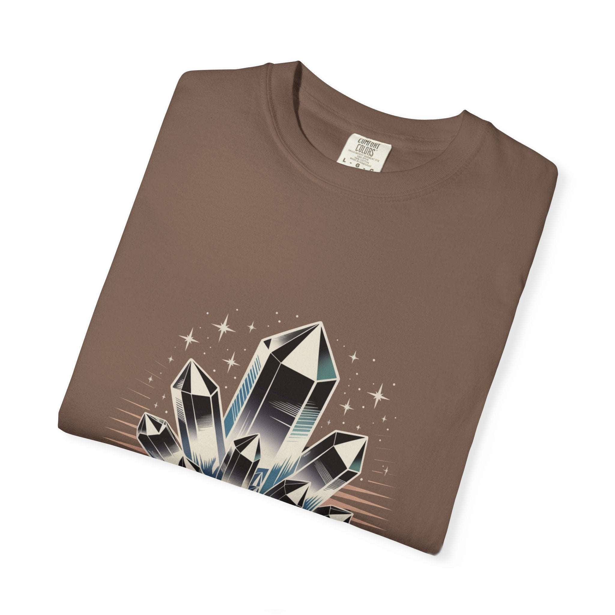 Folded brown t-shirt with crystal graphic design on a white background