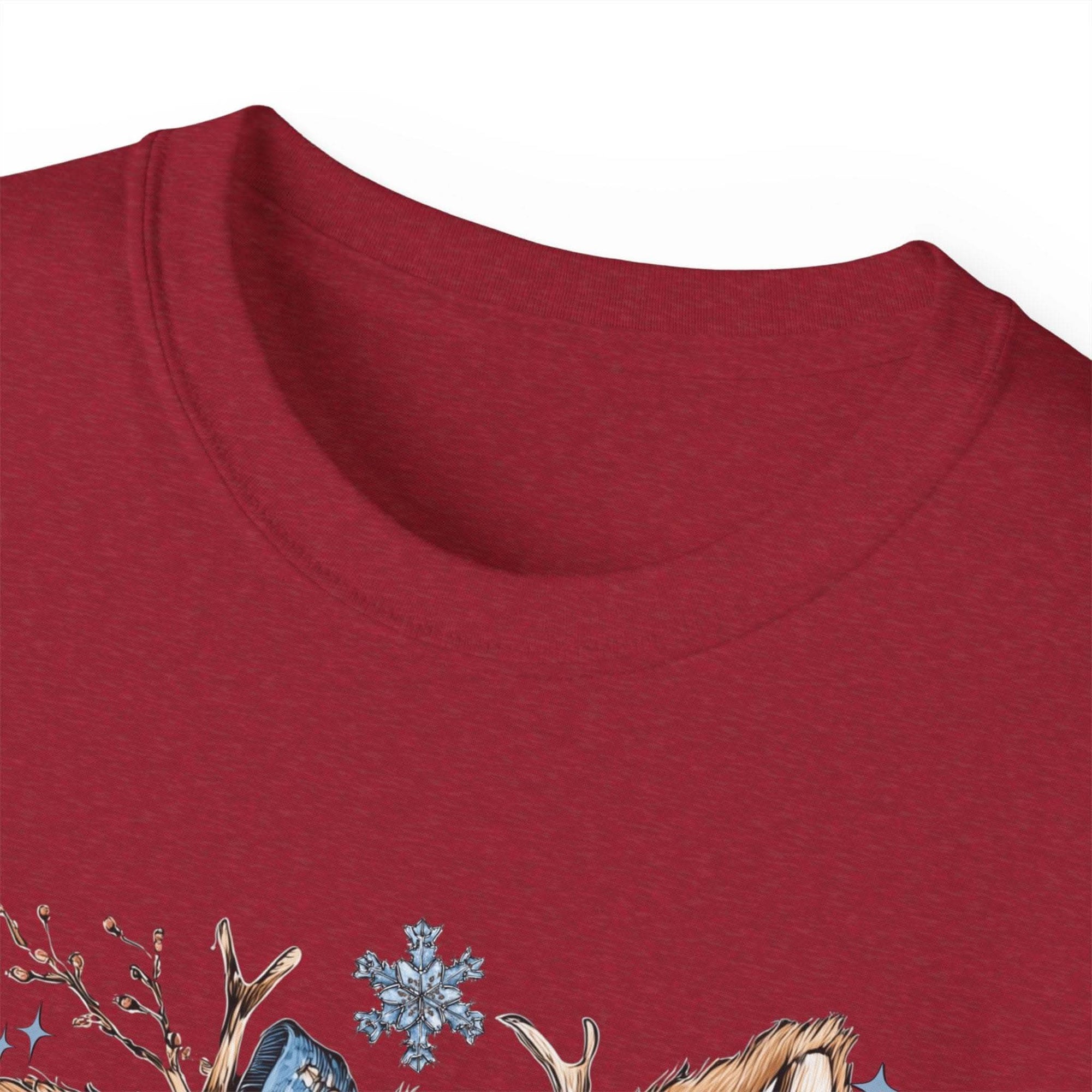 White t-shirt with retro patchwork reindeer design wearing blue scarf and surrounded by snowflakes